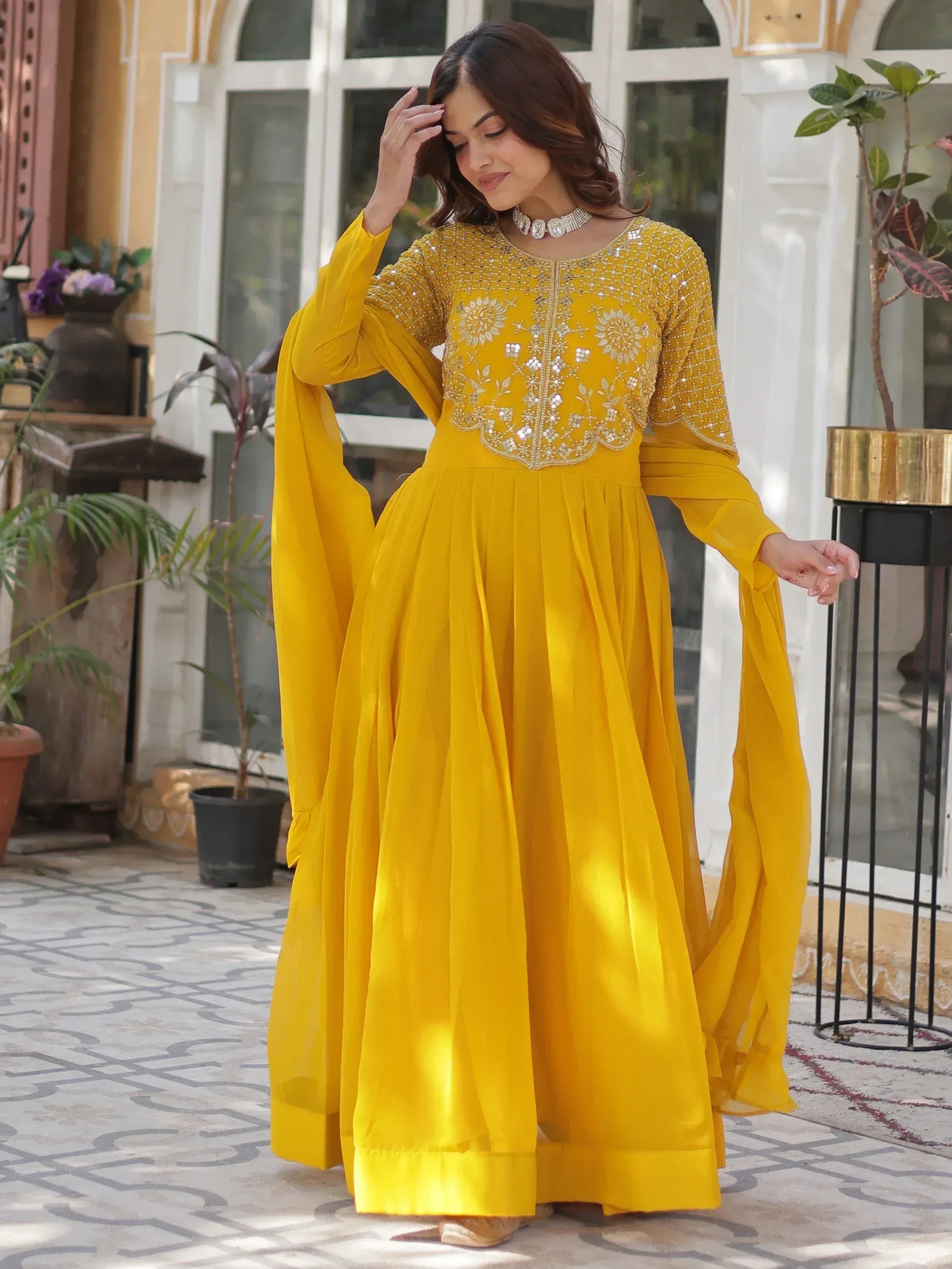 Yellow embroidered anarkali suit with flared sleeves, perfect for Indian ethnic wear occasions.