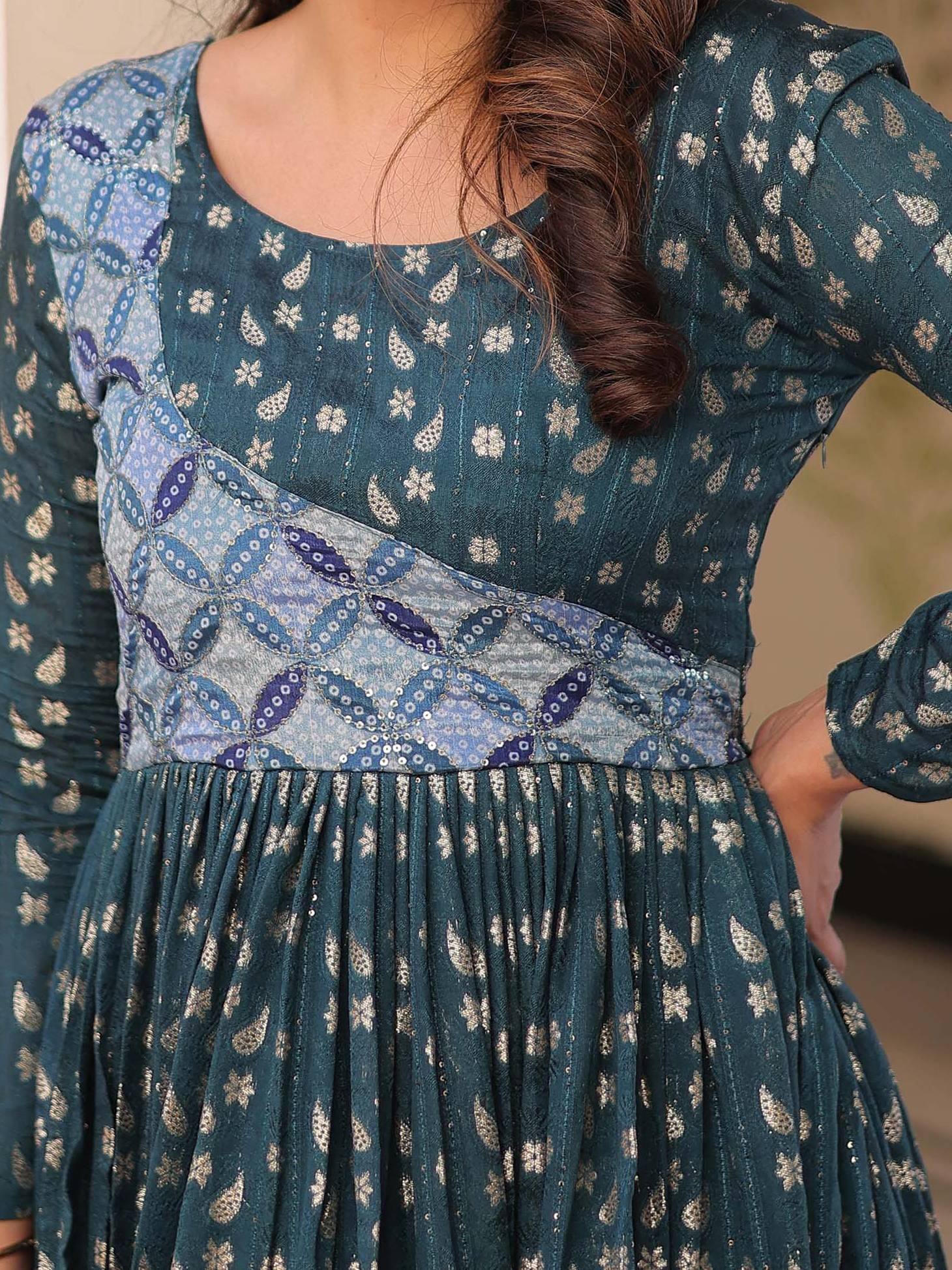 Teal ethnic gown with blue patchwork and floral print, perfect for Indian occasions