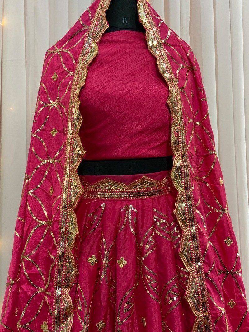Fuchsia lehenga choli with gold embroidery and sequin dupatta, perfect for Indian weddings and festivals