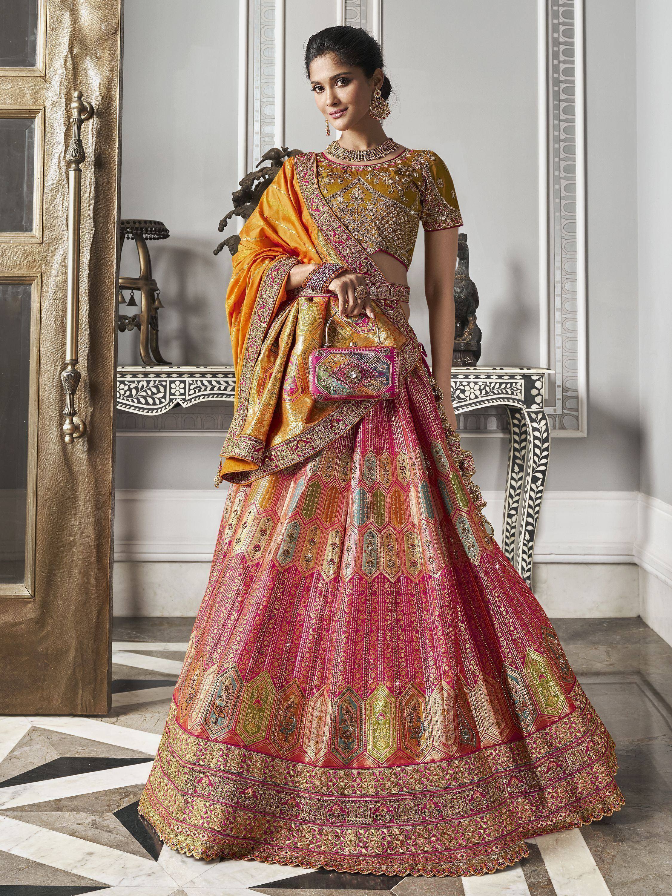 Designer lehenga choli in pink and gold with intricate embroidery, perfect for Indian weddings and festive occasions.