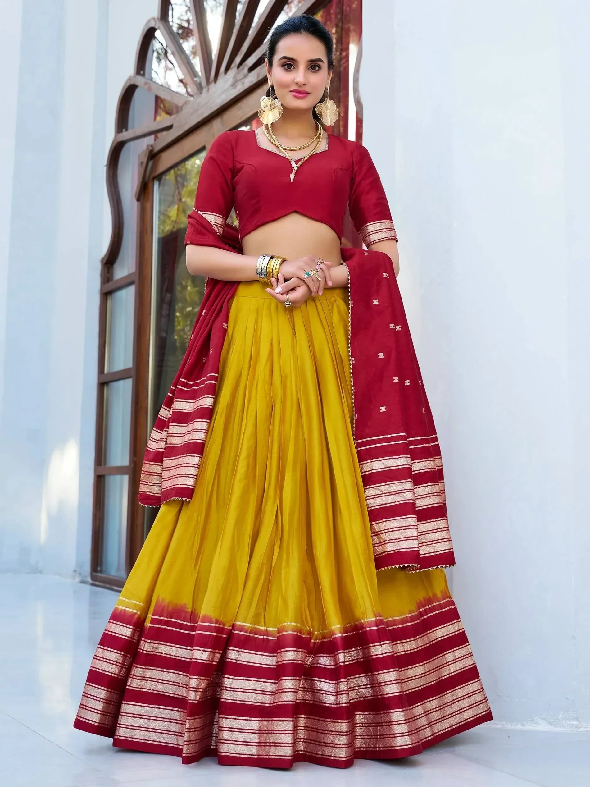 Maroon and yellow designer lehenga choli with striped border, perfect for Indian ethnic occasions