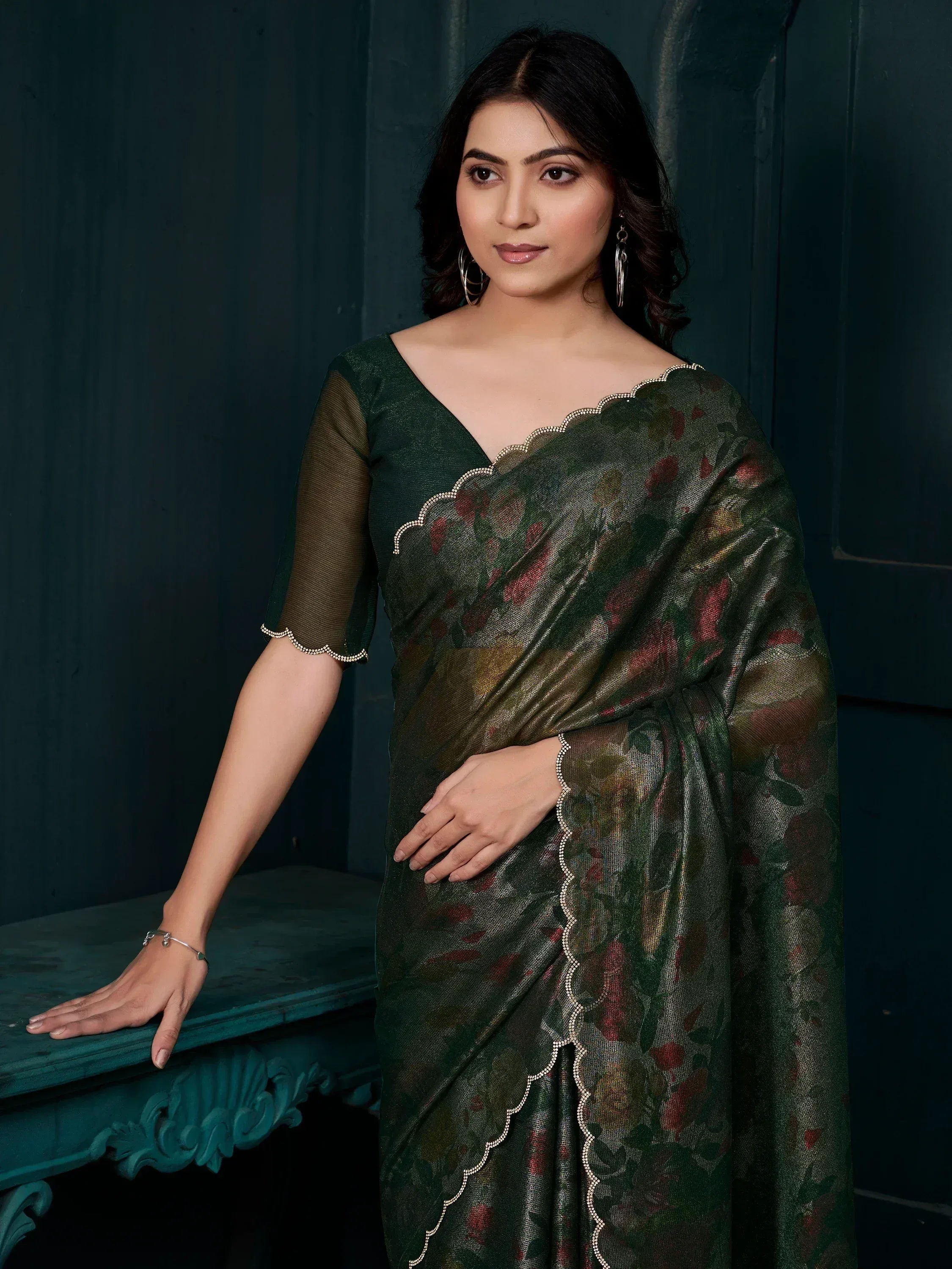 Elegant dark green floral saree with scalloped embellishments, perfect for Indian ethnic wear occasions.