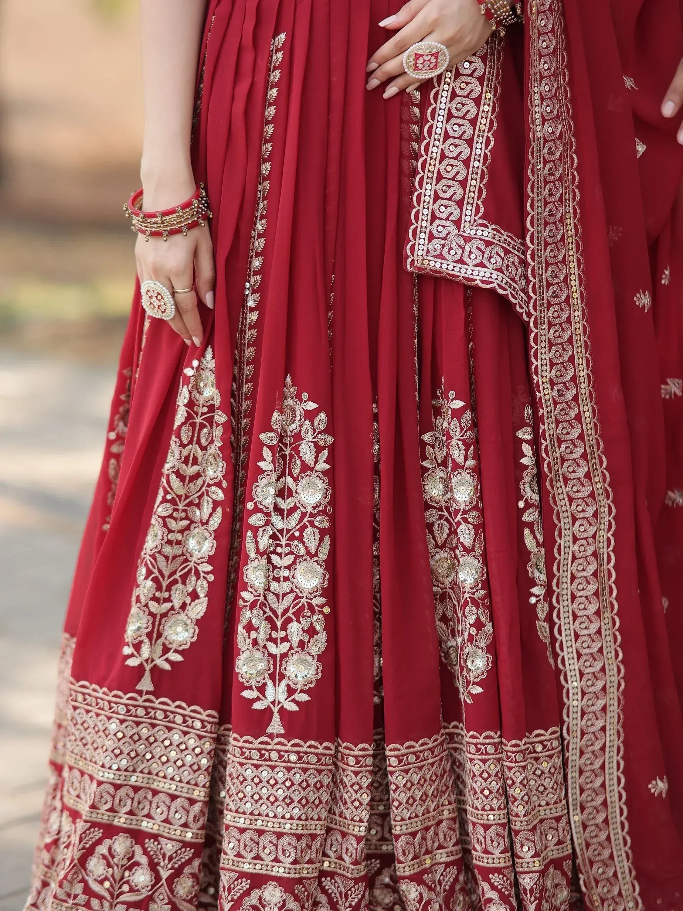 Red designer lehenga choli with gold embroidery and mirror work, perfect for Indian ethnic wear occasions