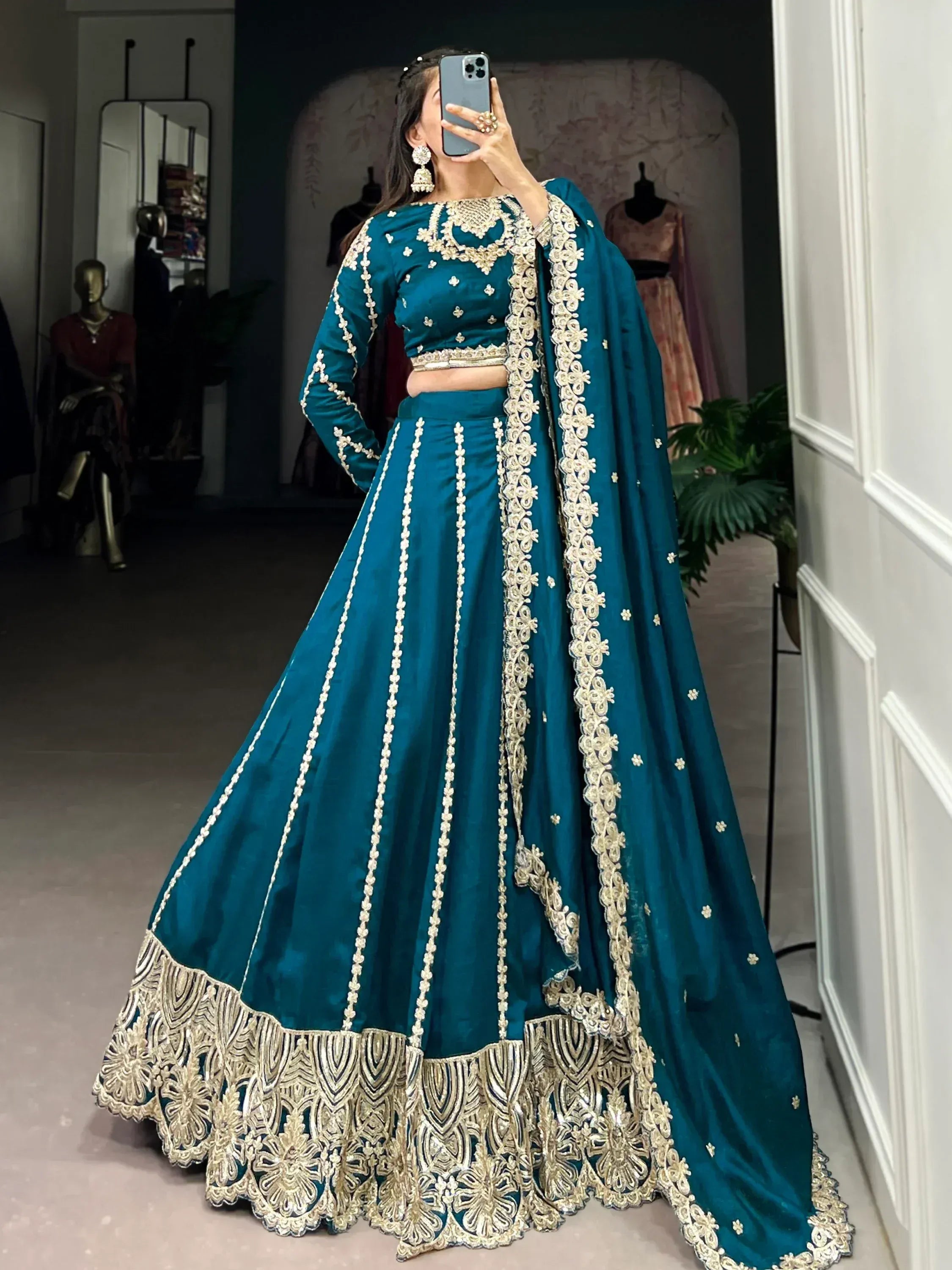 Teal designer lehenga choli with gold embroidery, perfect for Indian weddings and festive occasions.