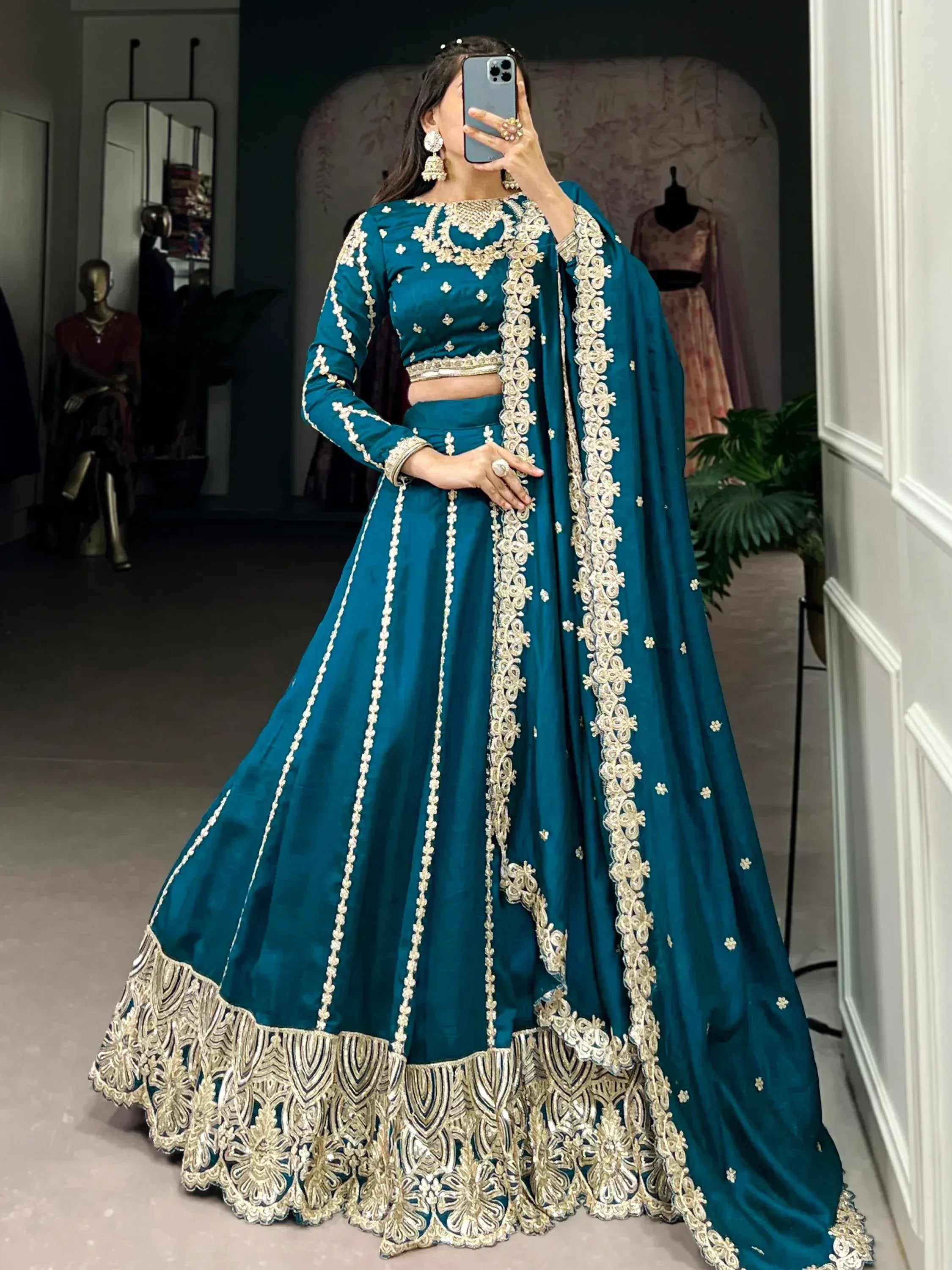 Teal designer lehenga choli with gold embroidery, perfect for Indian weddings and festive occasions.