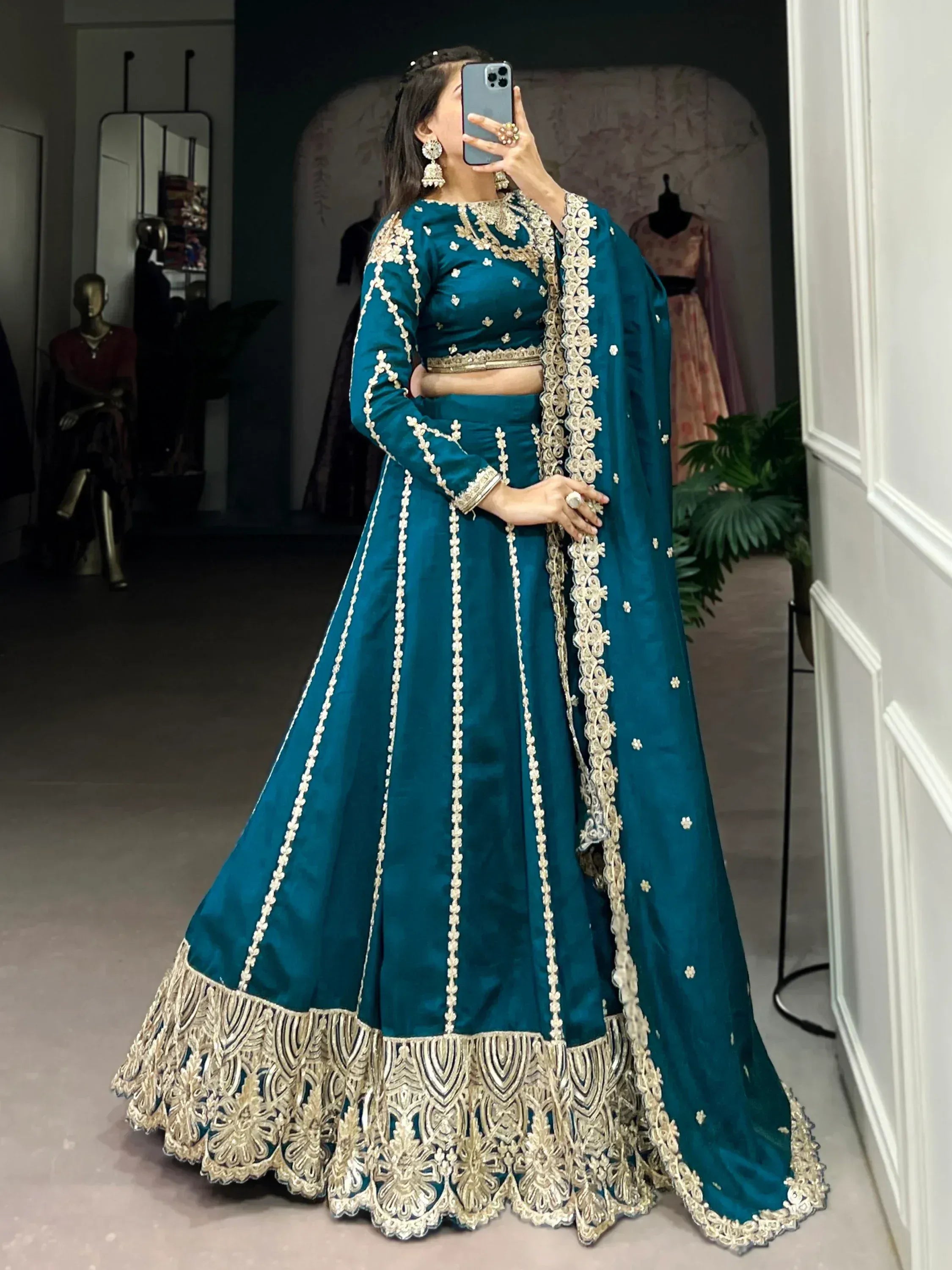 Teal blue designer lehenga choli with gold embroidery, perfect for Indian weddings and festive occasions