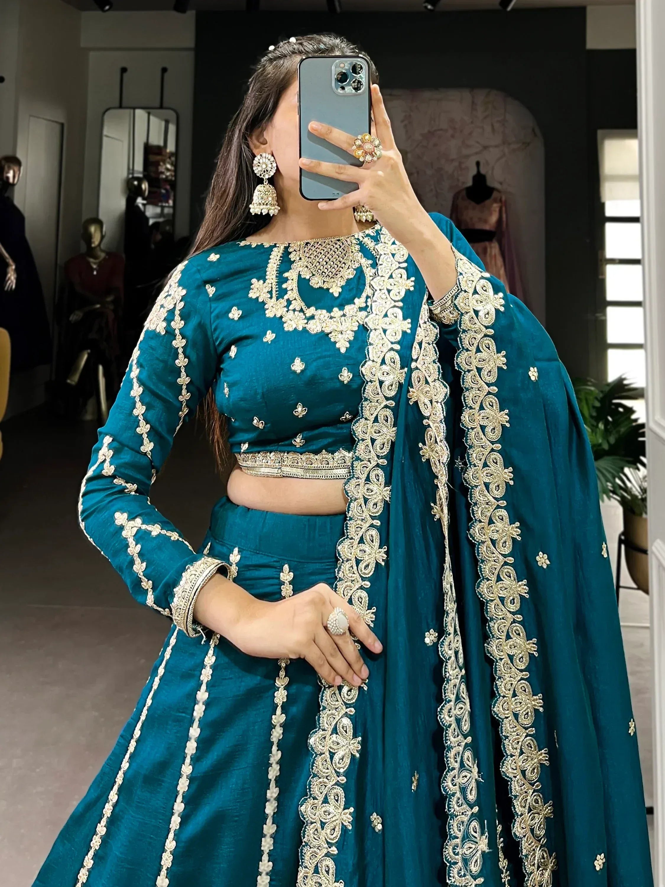 Teal blue embroidered lehenga choli with gold detailing, perfect for Indian ethnic wear occasions.