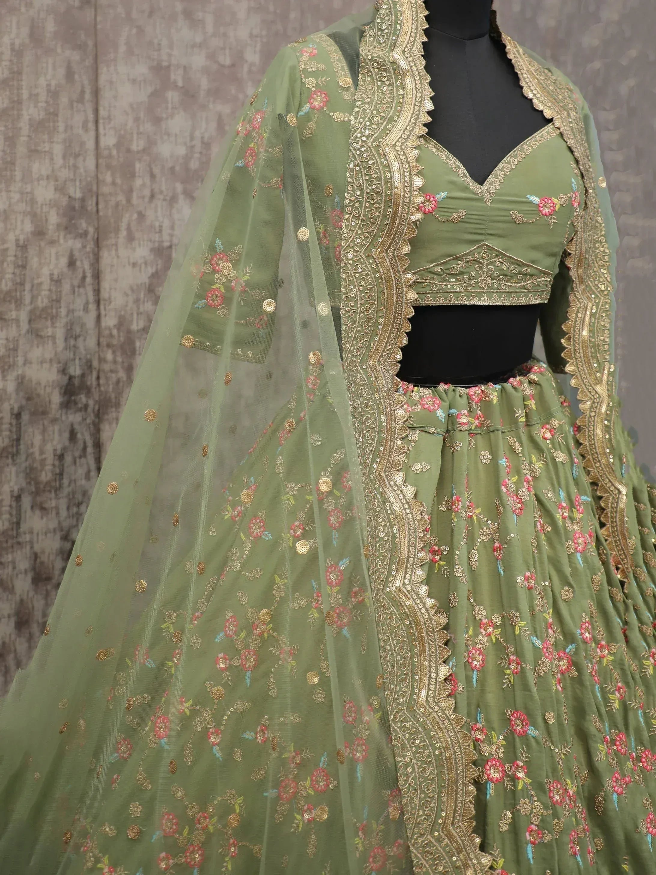 Olive green embroidered lehenga choli with floral motifs and gold detailing, perfect for Indian ethnic wear.