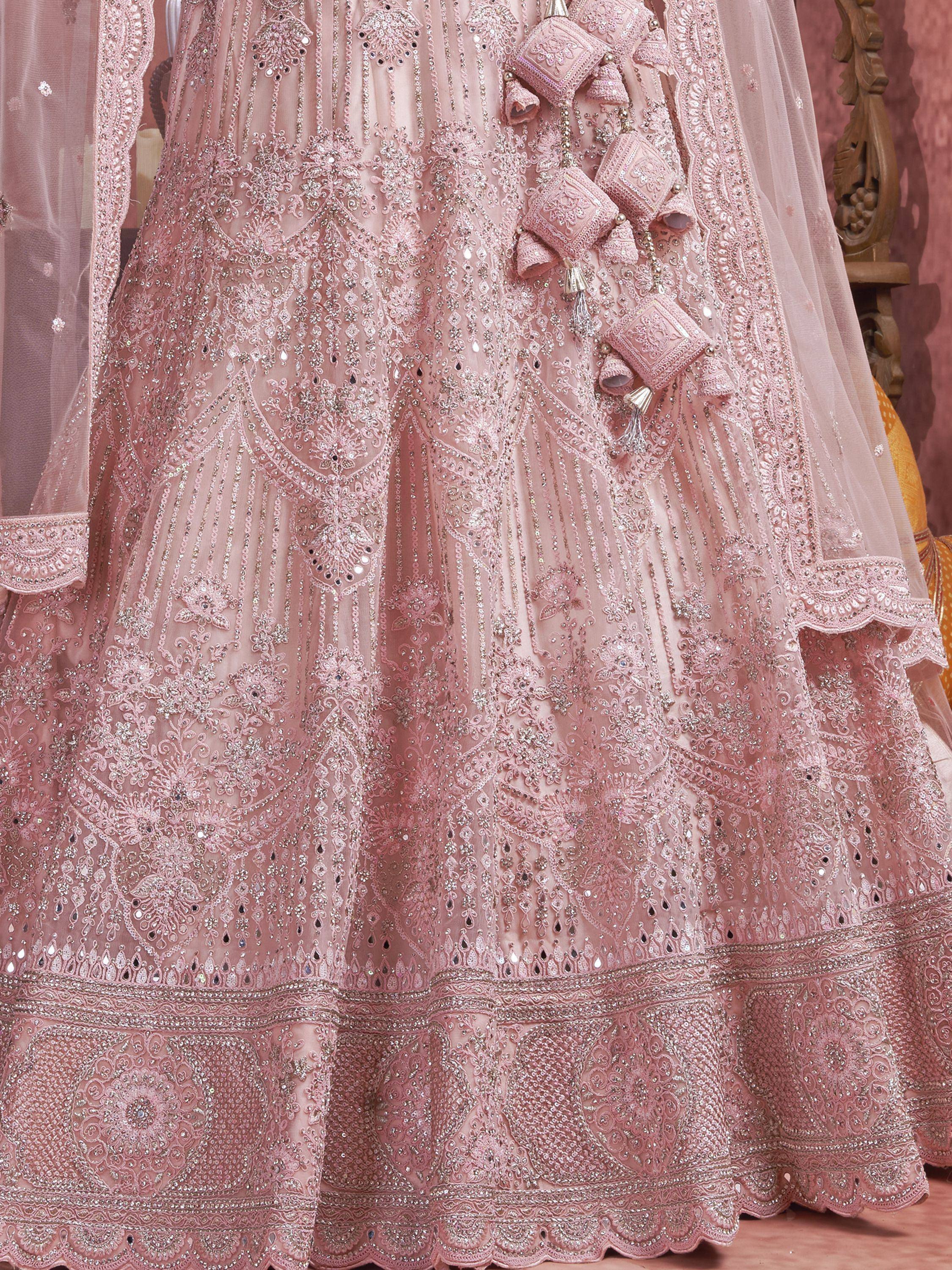 Pink designer lehenga choli with heavy embroidery, mirror work, and tassels for Indian weddings