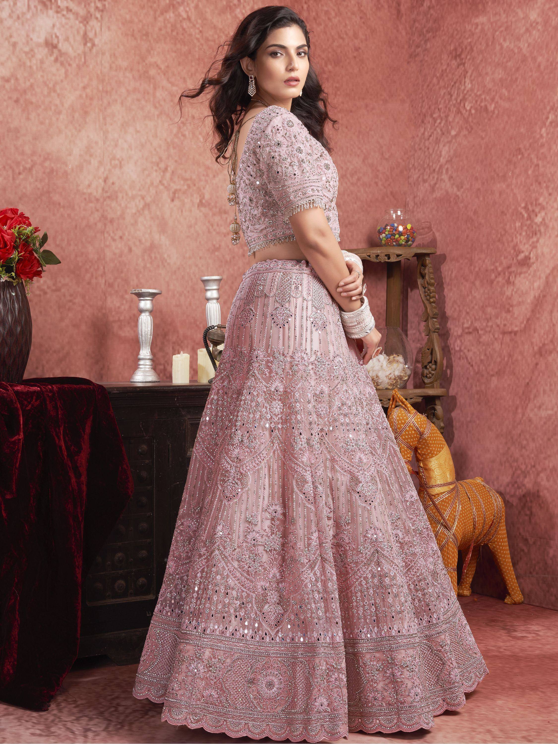 Pink embroidered lehenga choli with mirror work, perfect for Indian weddings and festive occasions