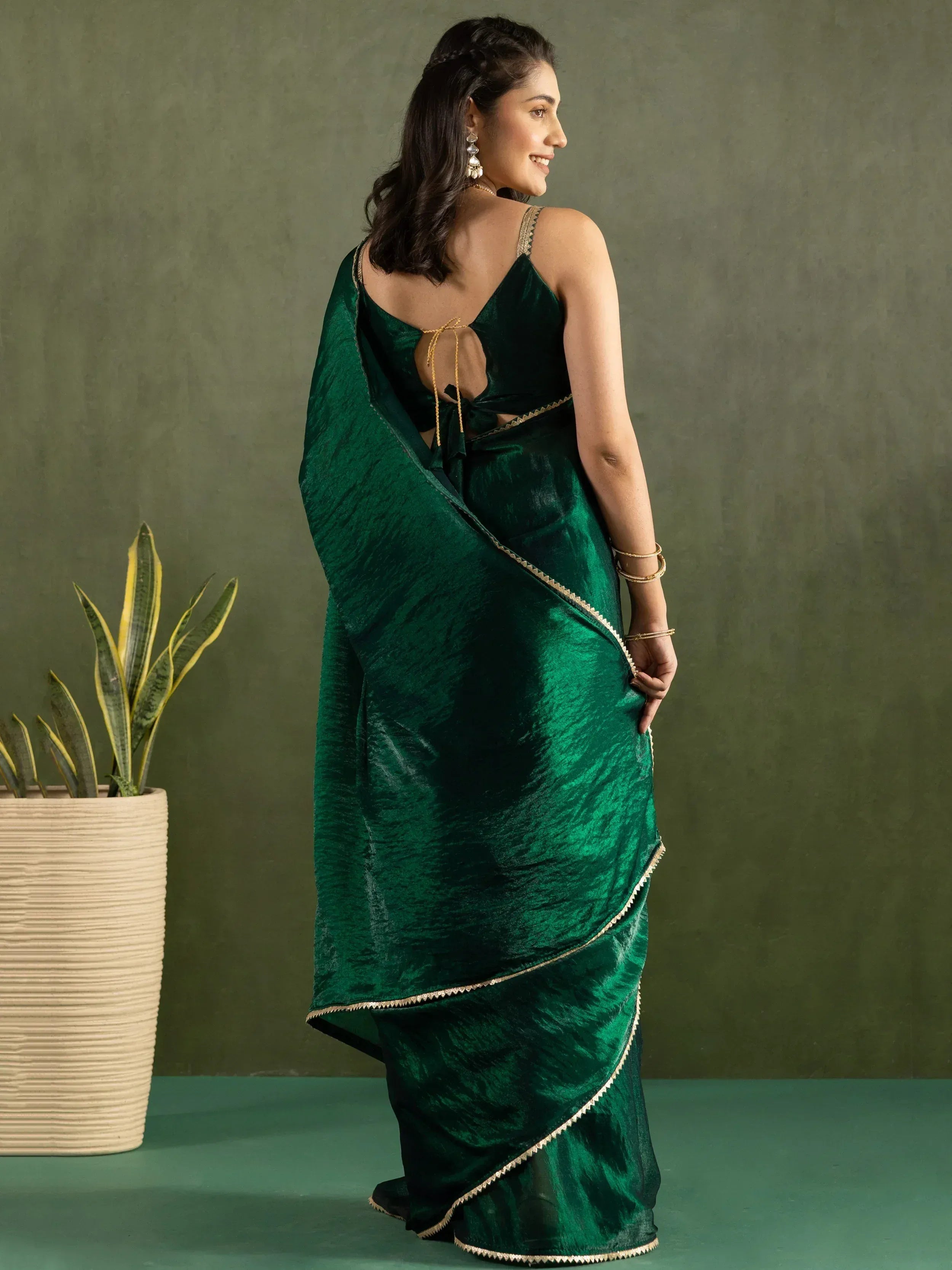 Emerald green velvet saree with gold trim, backless blouse, ethnic Indian wear