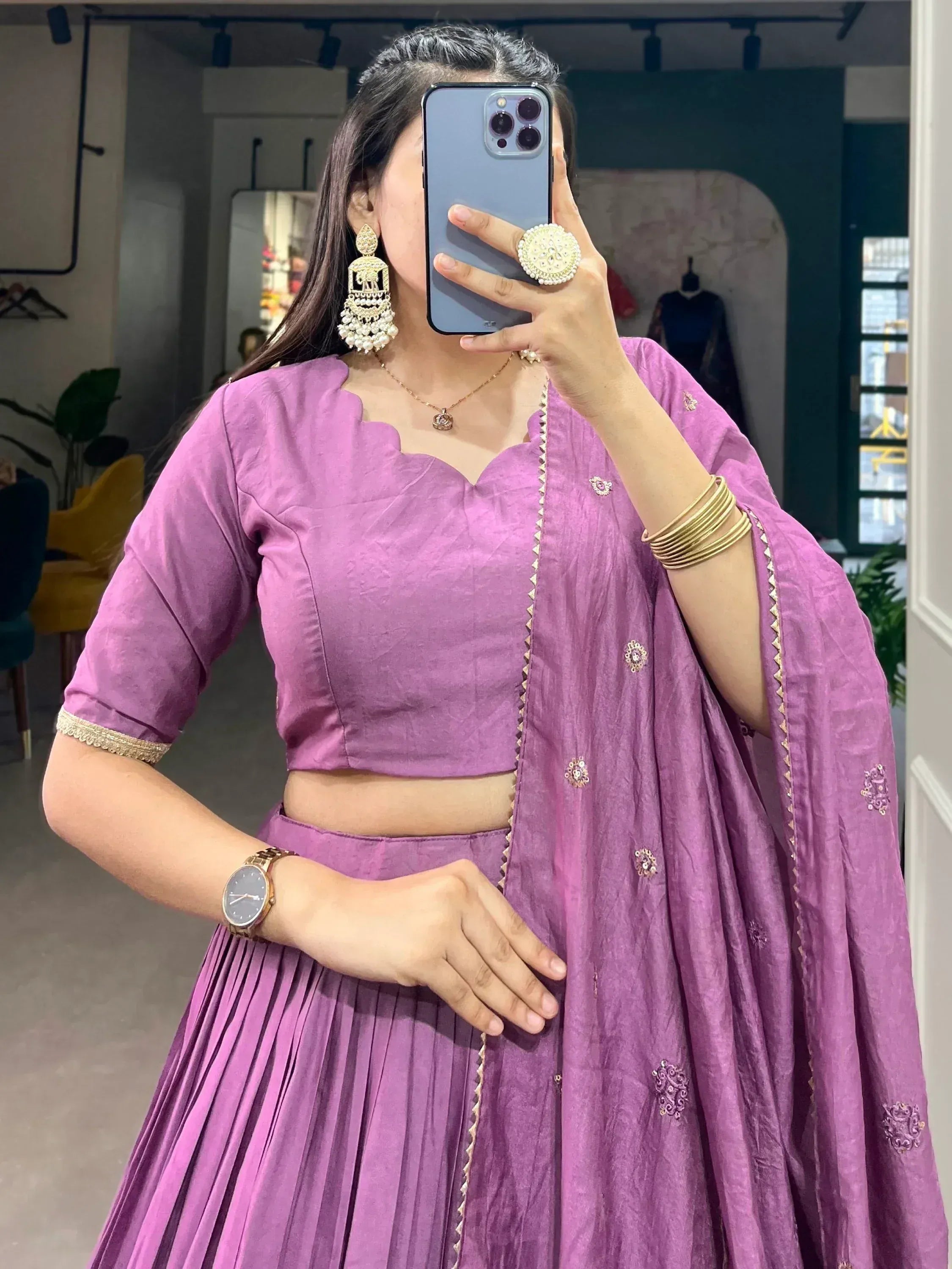 Purple ethnic lehenga choli with gold embroidery, mirror selfie in boutique