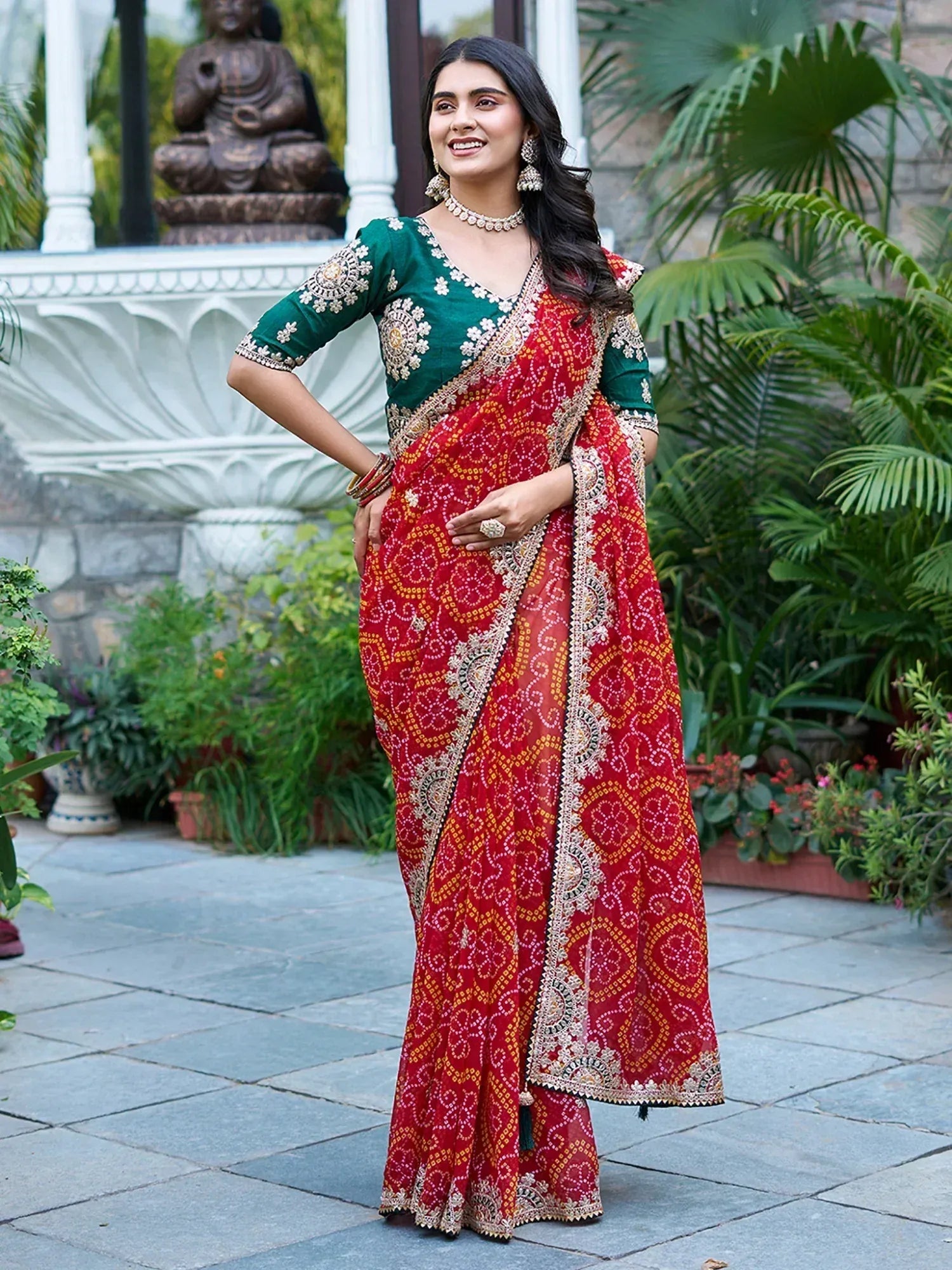 Woman in red printed saree with green embroidered blouse, traditional Indian ethnic wear