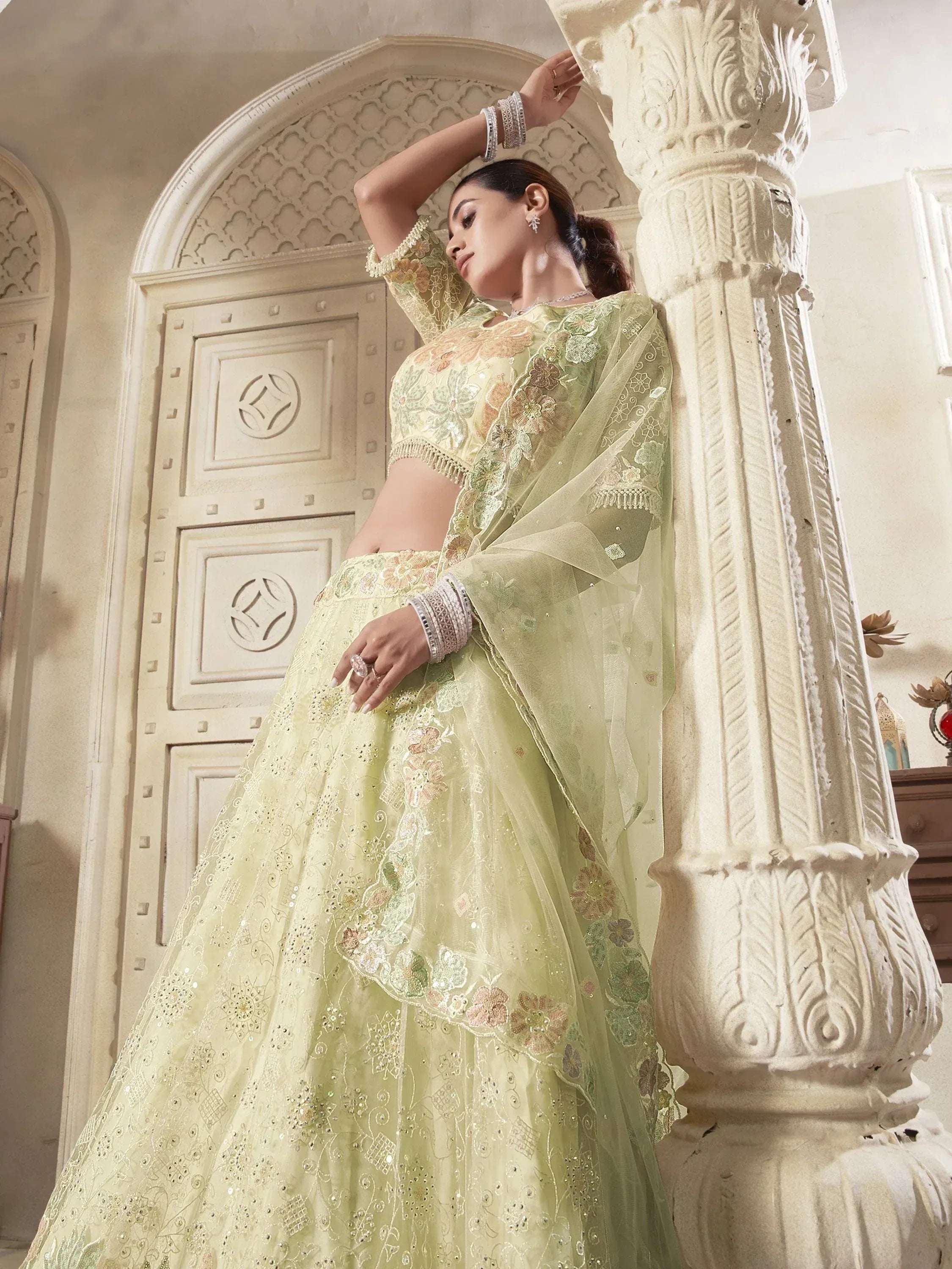 Elegant light green designer lehenga choli with floral embroidery, perfect for Indian ethnic wear occasions.