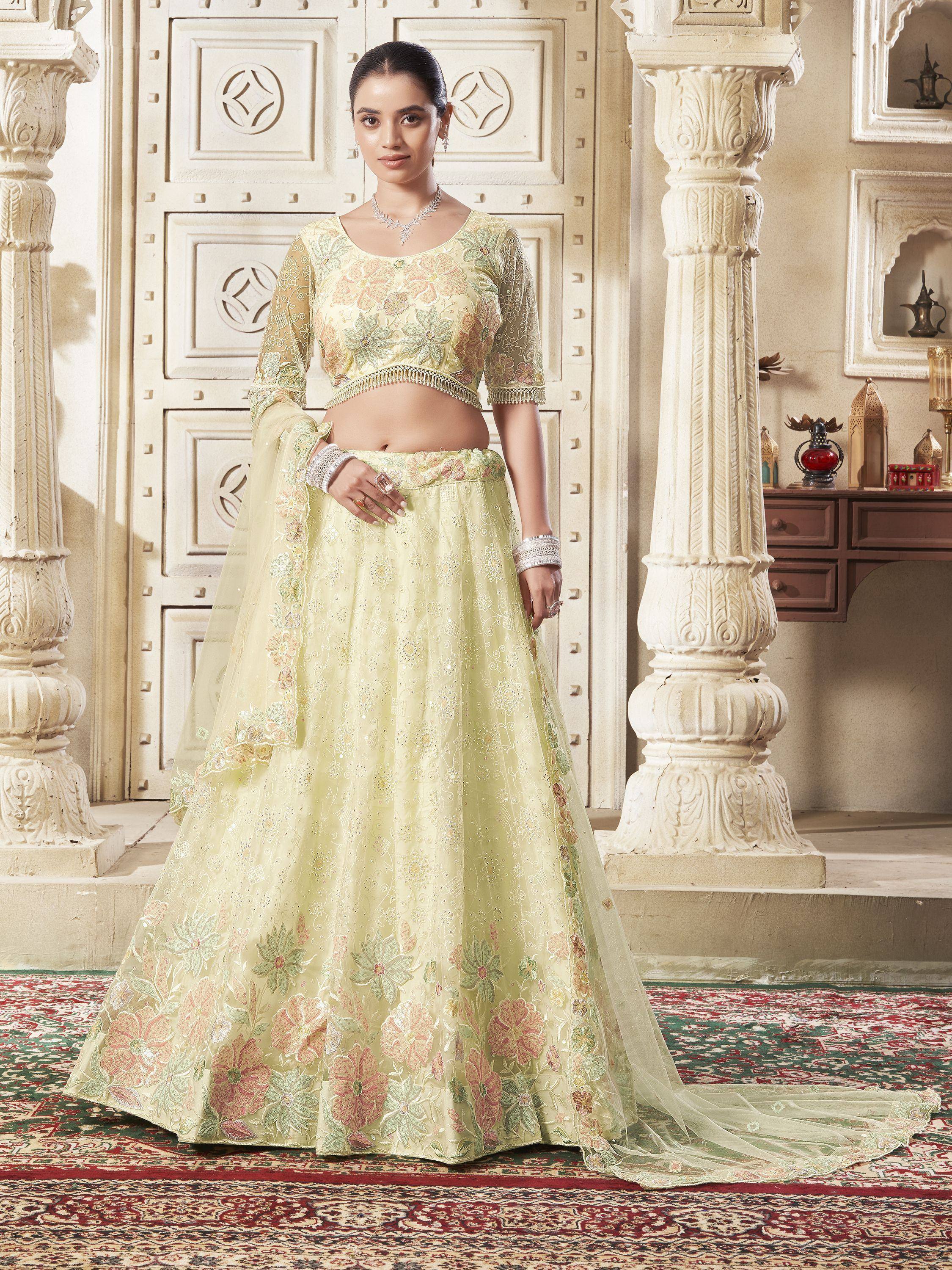 Pale green embroidered lehenga choli with floral motifs, perfect for Indian weddings and festive occasions.