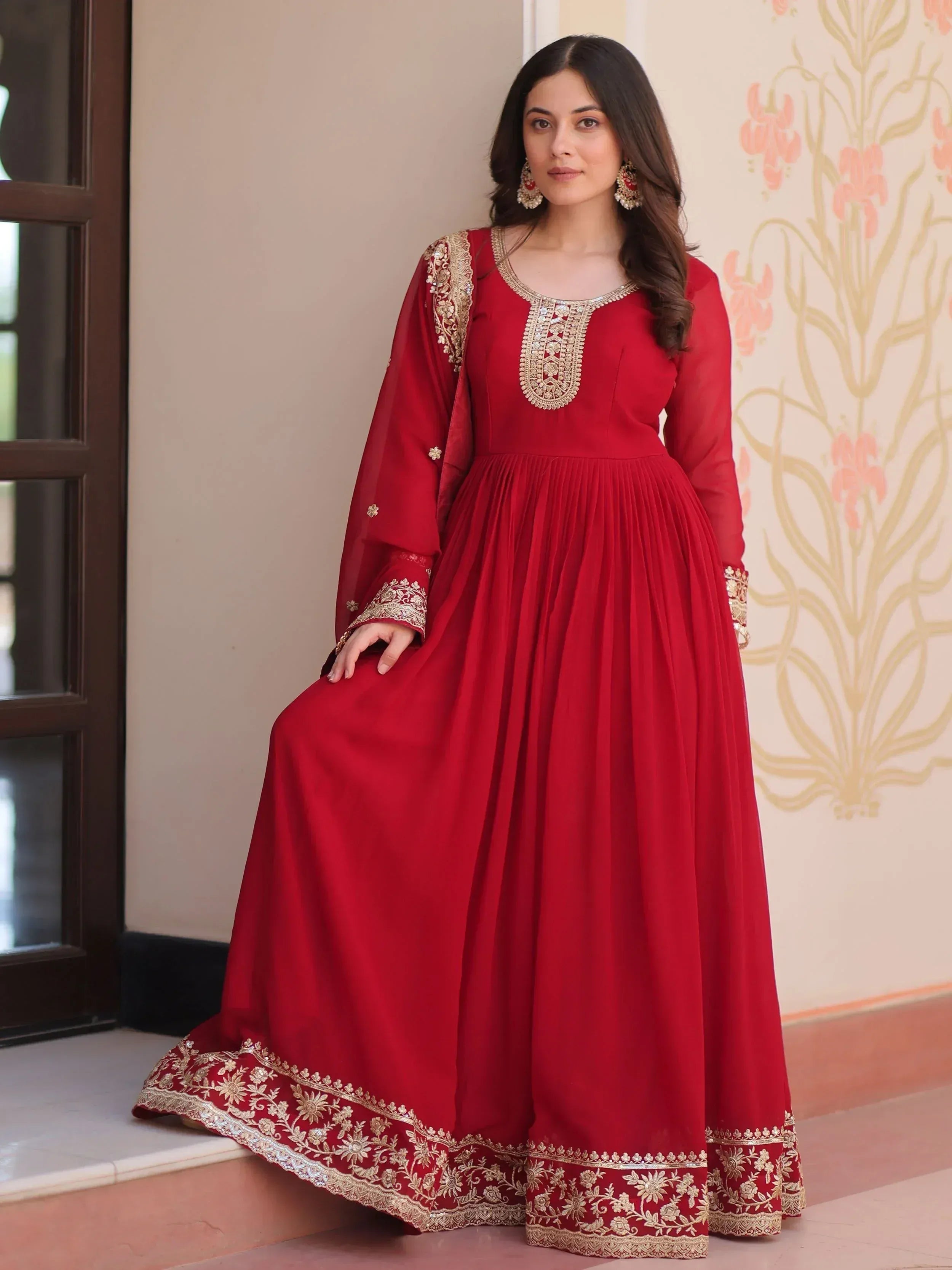 Red ethnic gown with gold embroidery, perfect for Indian weddings and festive occasions