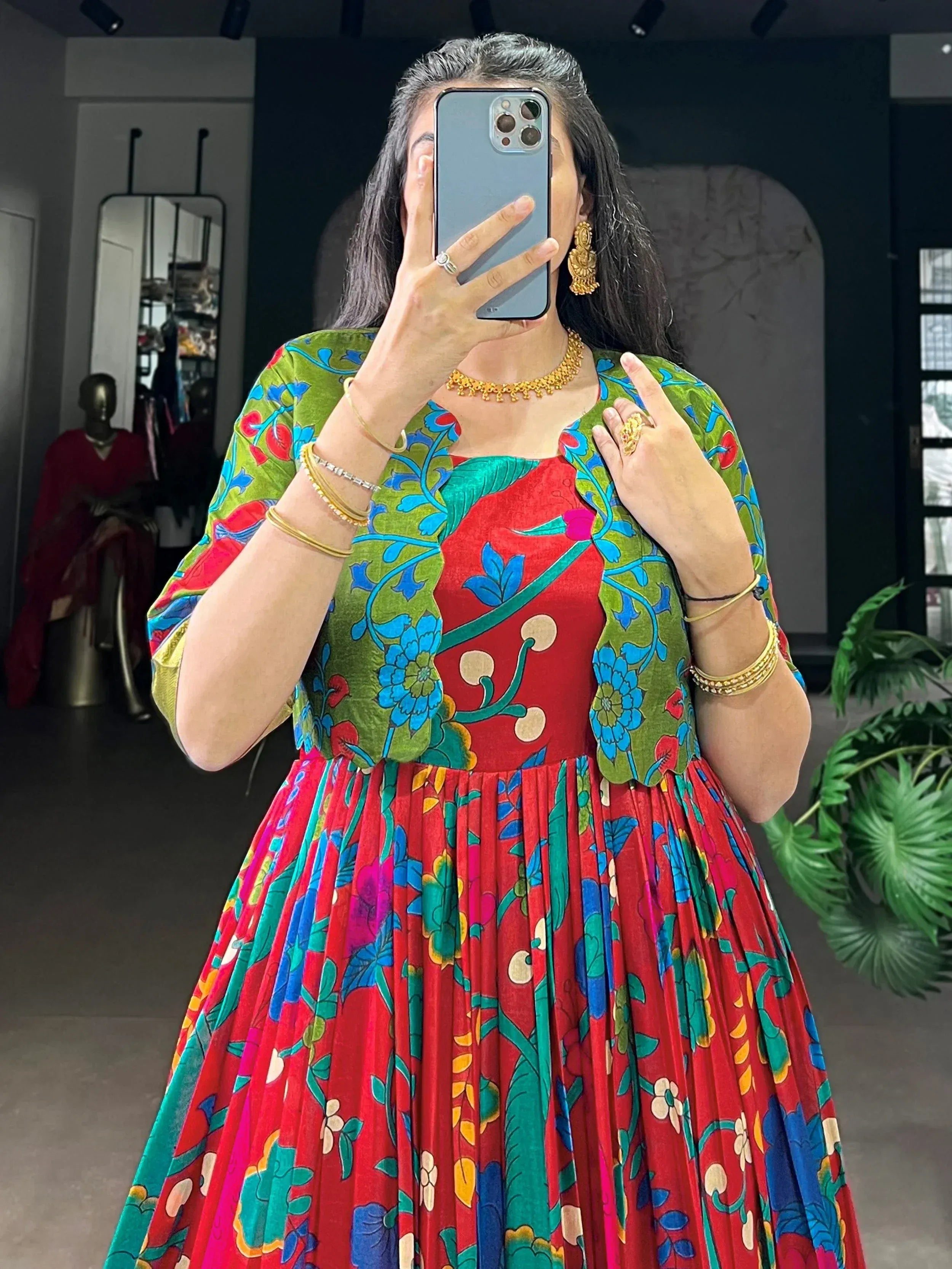 Vibrant floral ethnic gown with red and green hues, perfect for festive occasions