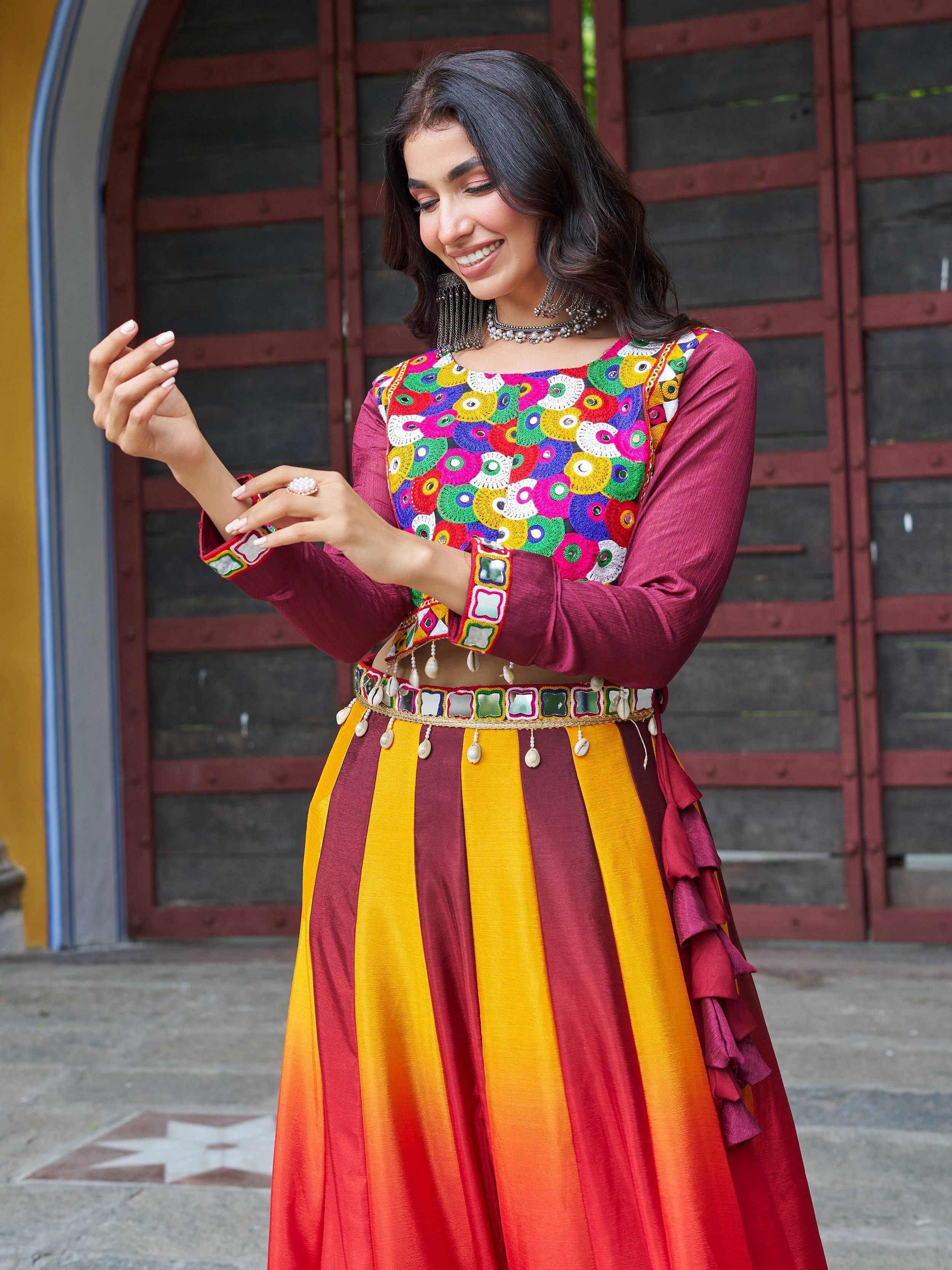 Woman in colorful embroidered Indian ethnic wear with mirror work and striped skirt