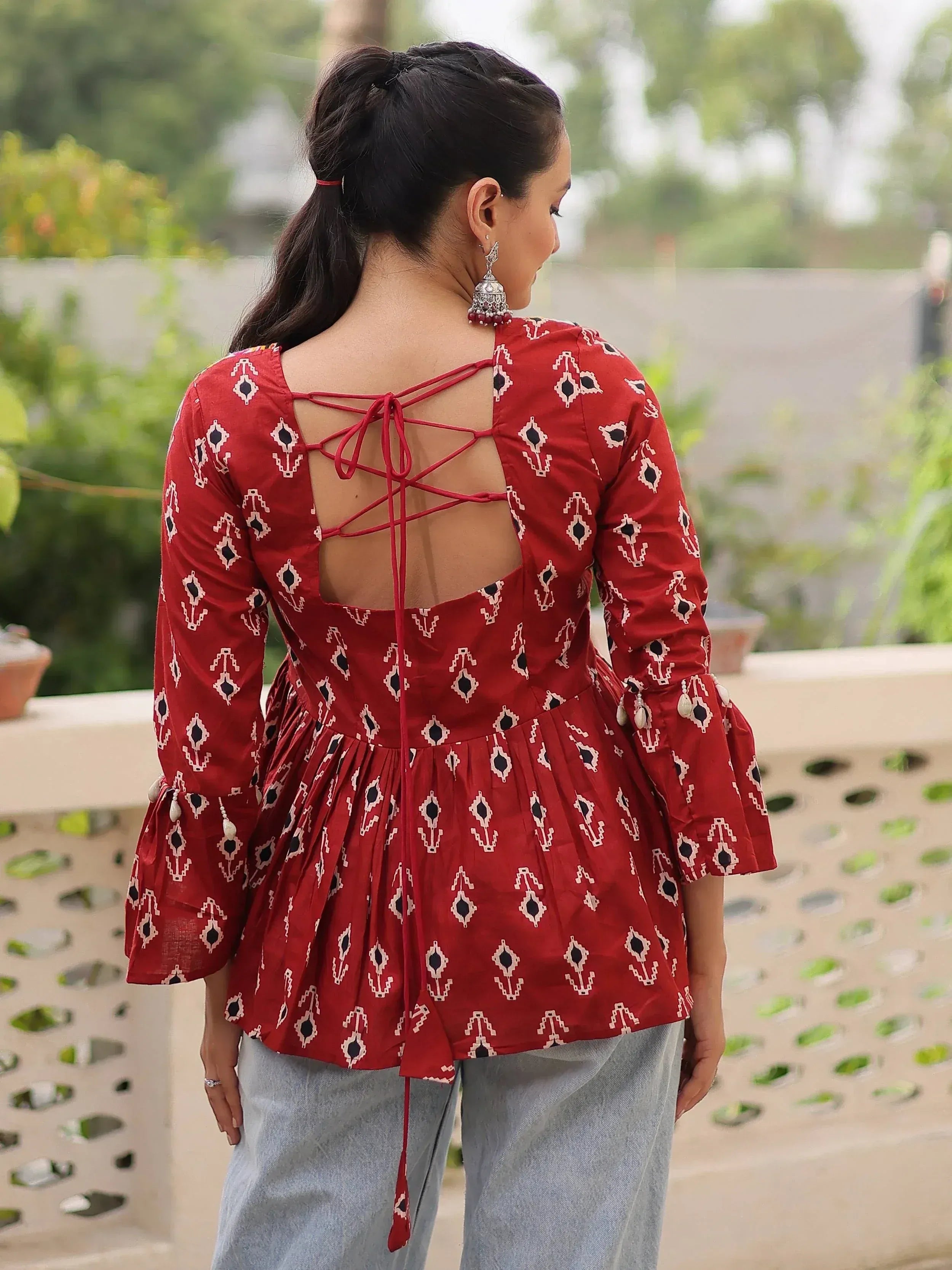 Red ethnic printed top with back tie-up and bell sleeves, paired with palazzo pants