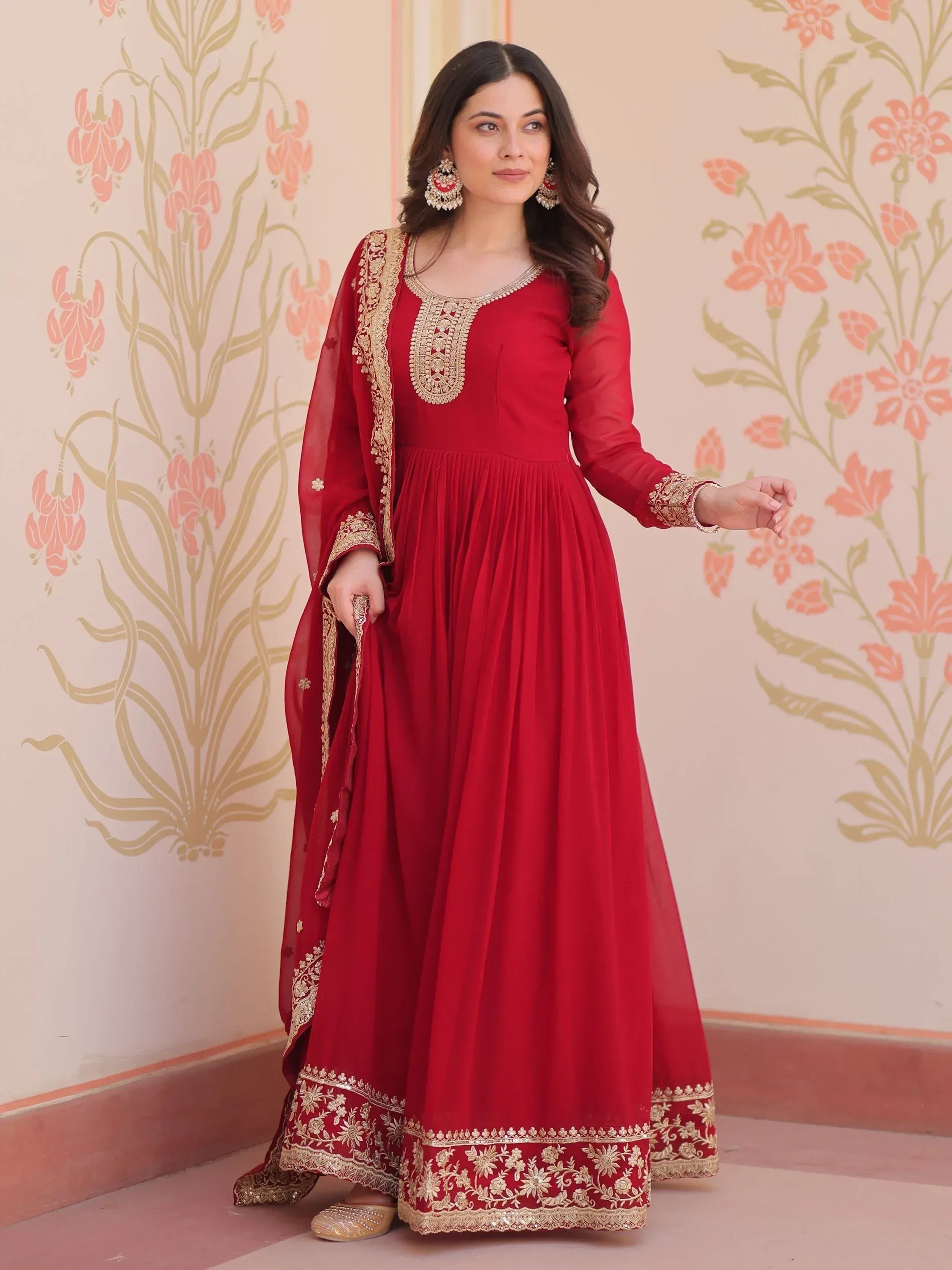 Red ethnic gown with gold embroidery, perfect for Indian celebrations and festive occasions.