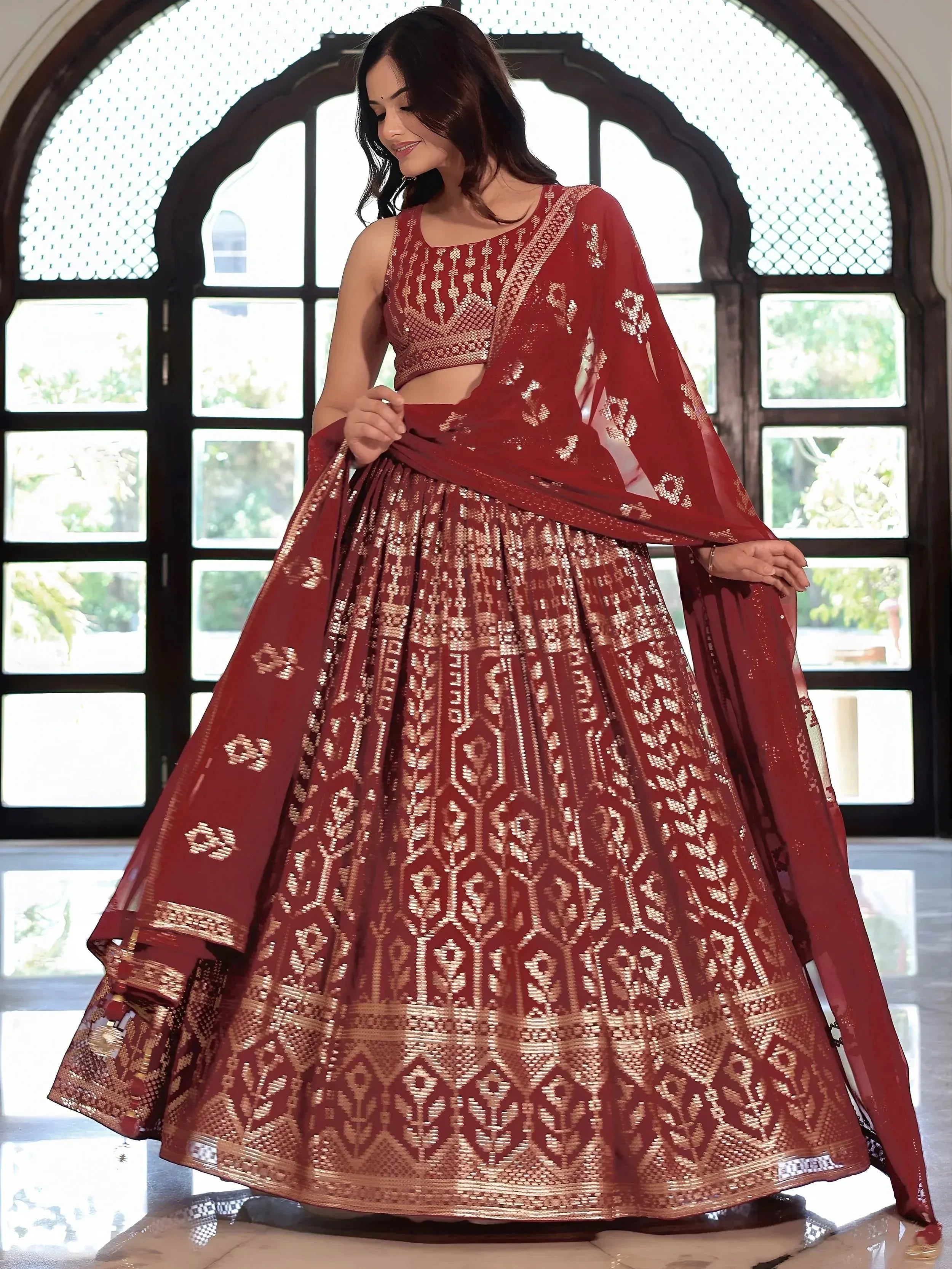 Maroon designer lehenga choli with gold embroidery, perfect for Indian ethnic wear and festive occasions.