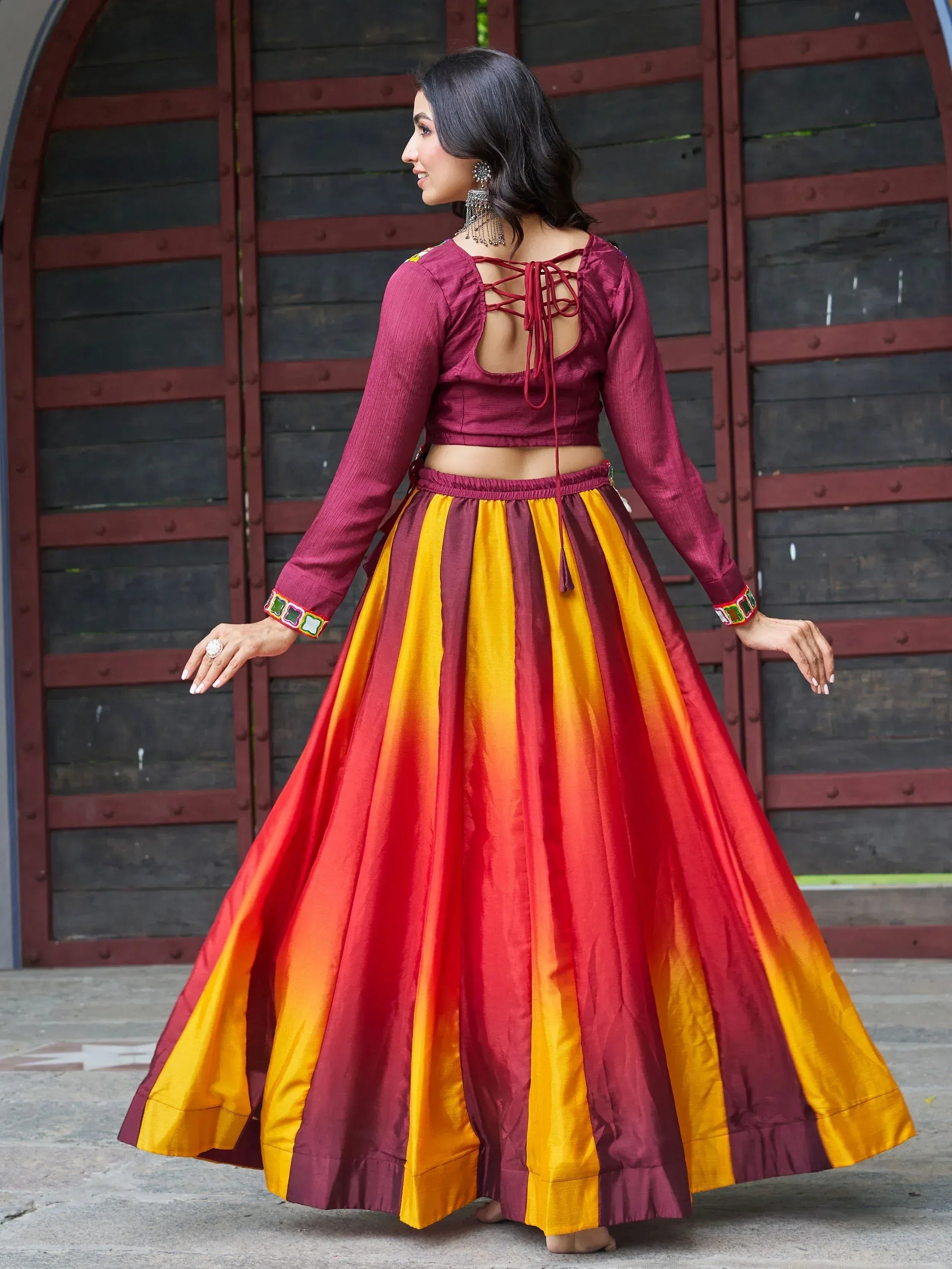 Woman in maroon and yellow striped ethnic lehenga choli with back tie blouse, perfect for Indian festivals and weddings