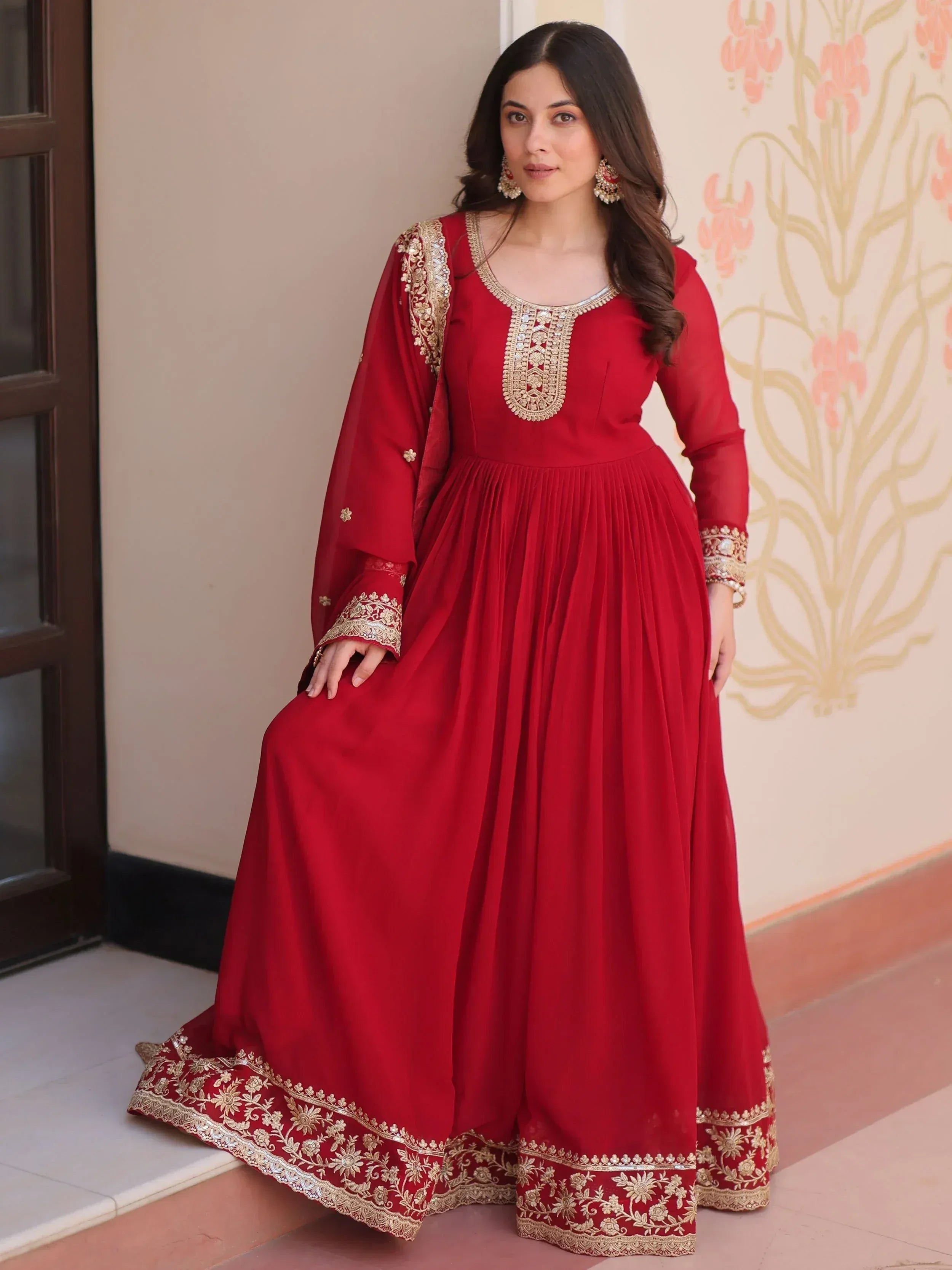 Red ethnic gown with gold embroidery, perfect for Indian weddings and festive occasions