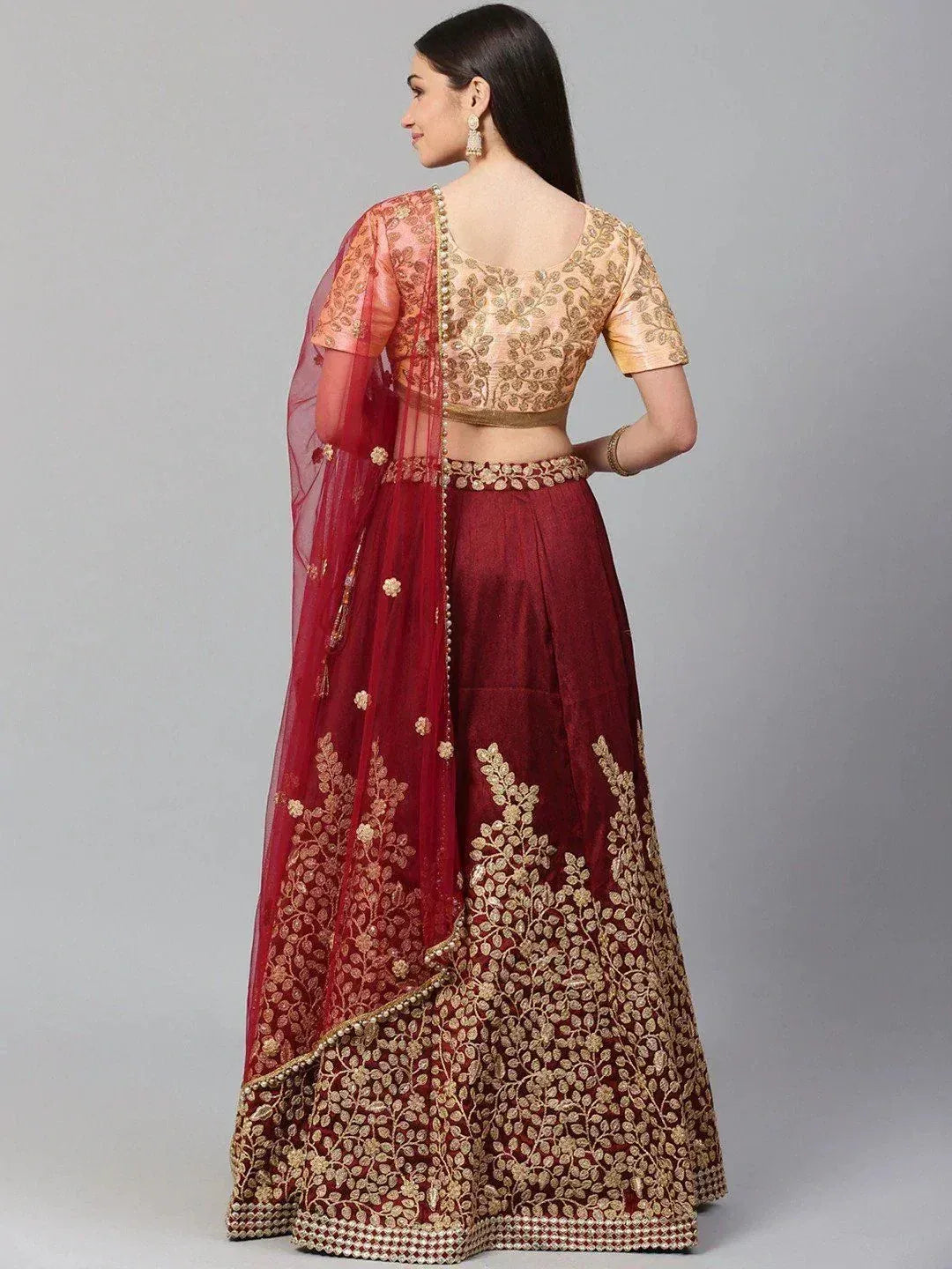 Maroon lehenga choli with gold embroidery, sheer dupatta, and designer blouse for Indian ethnic wear