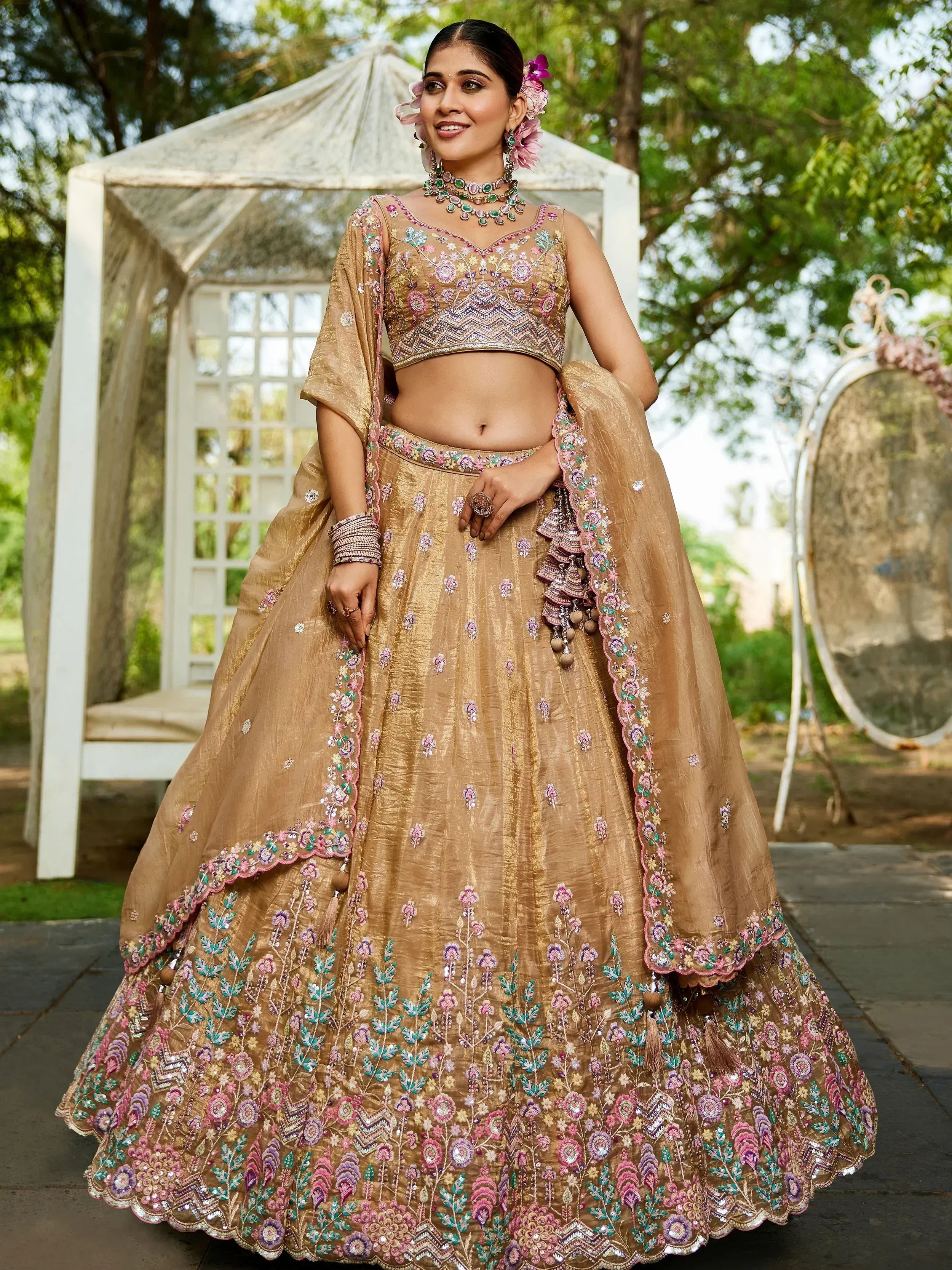 Elegant gold lehenga choli with floral embroidery, perfect for Indian weddings and festive occasions.