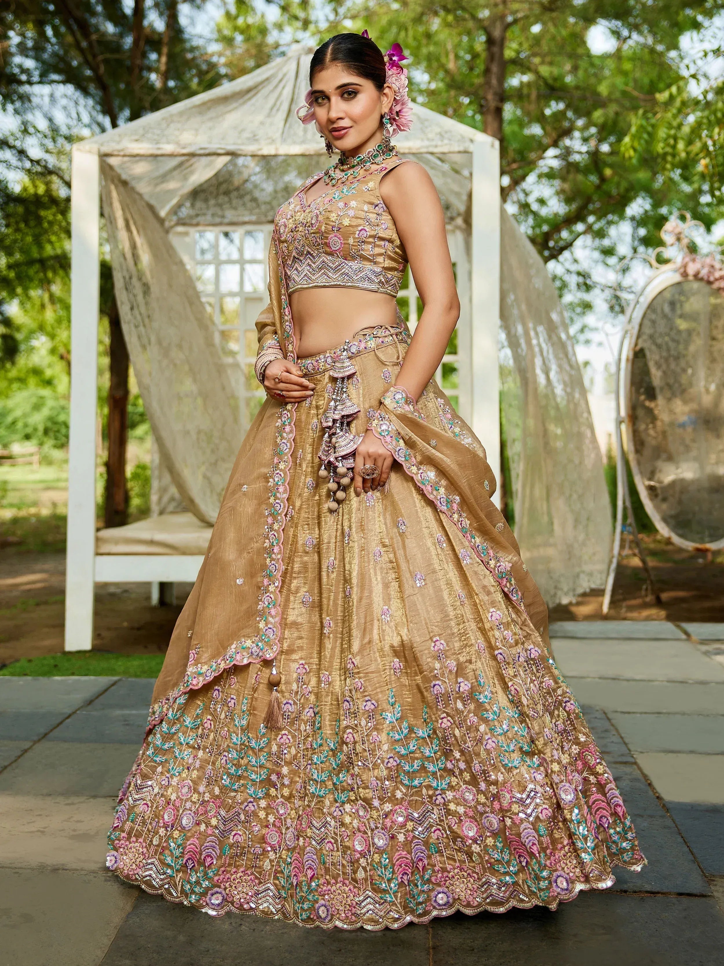 Gold embroidered lehenga choli with floral designs, perfect for Indian weddings and festive occasions