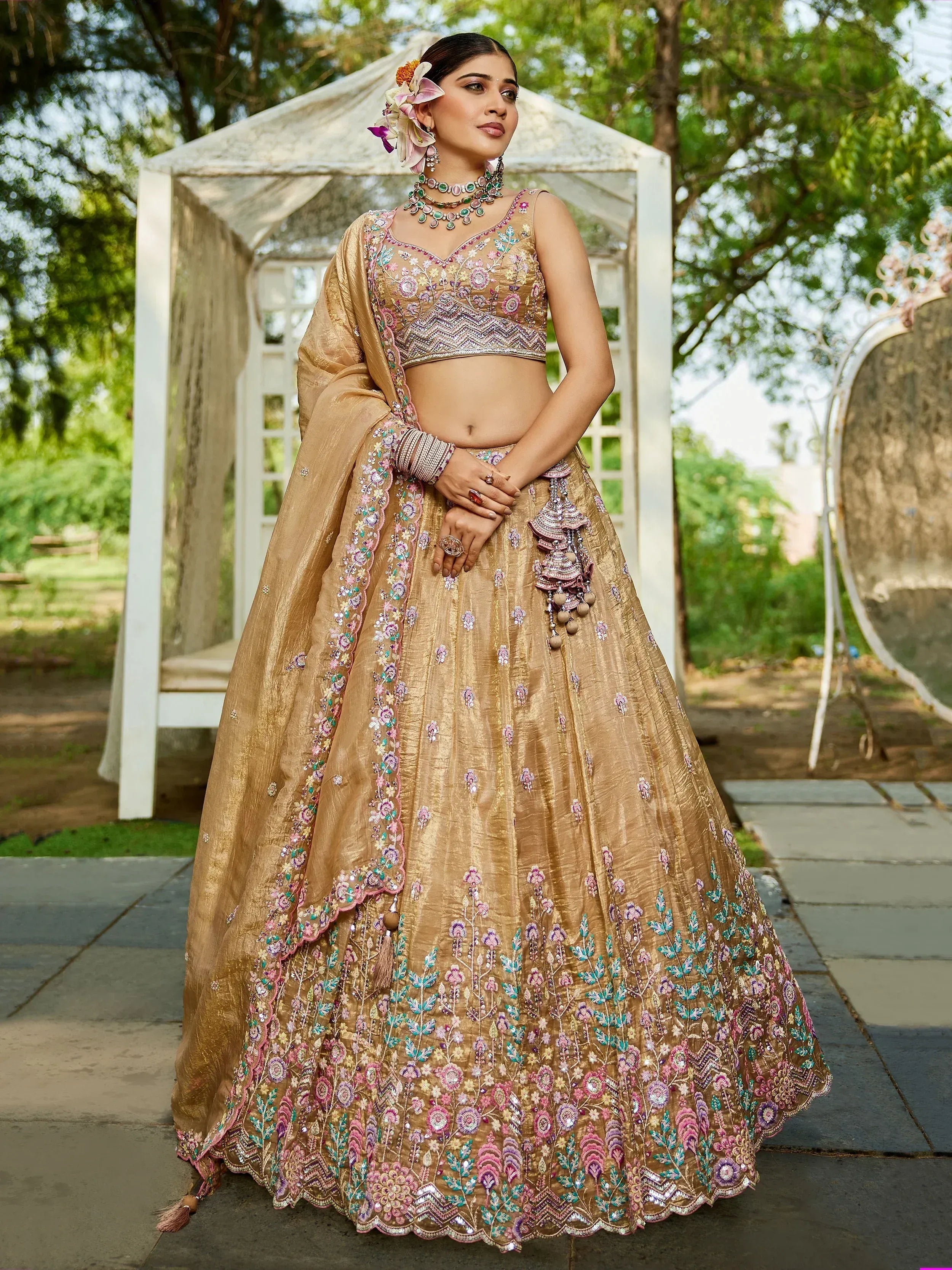Gold embroidered lehenga choli with floral detailing, perfect for Indian weddings and festive occasions.