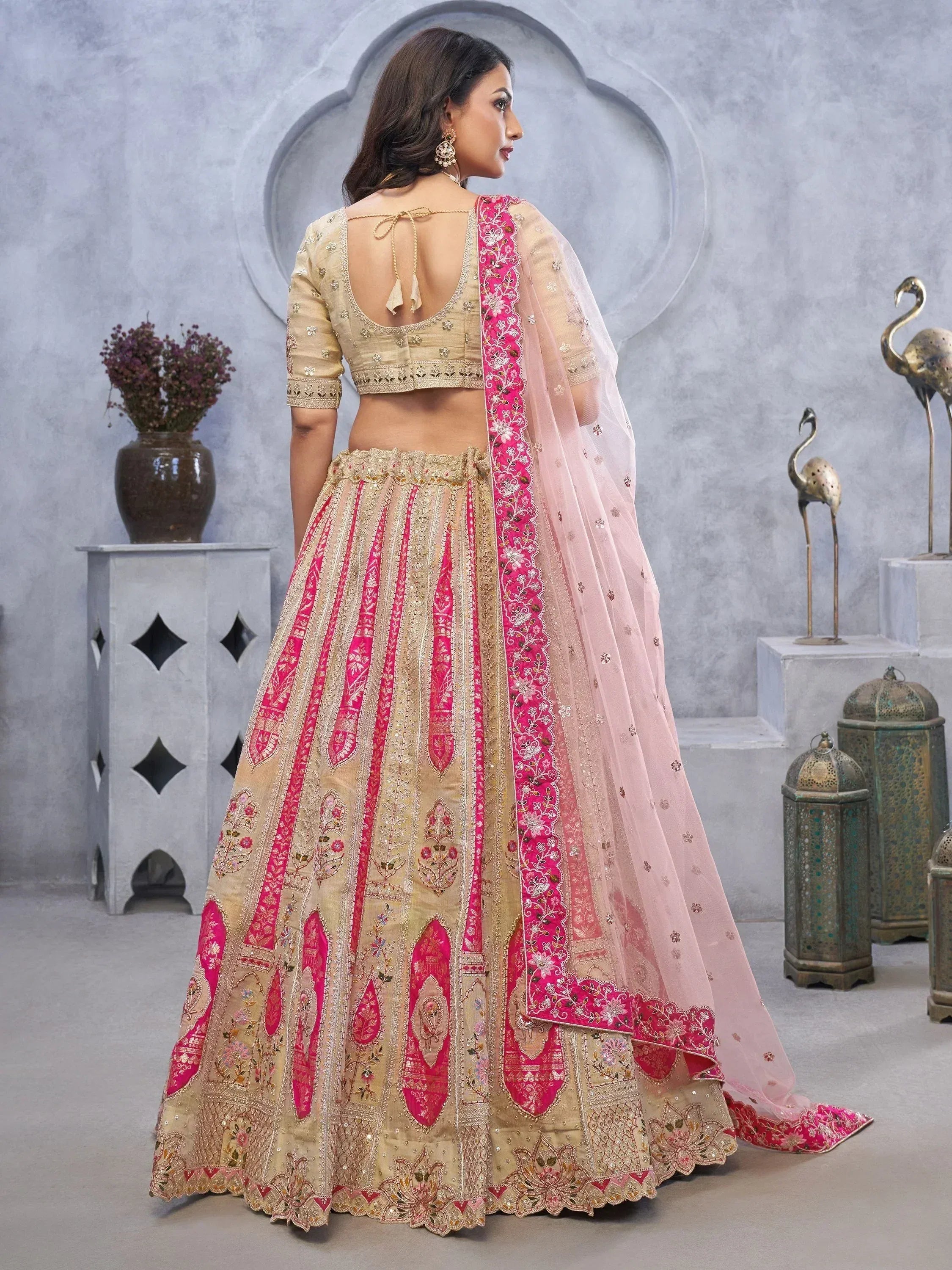 Beige and pink embroidered lehenga choli with floral dupatta, perfect for Indian weddings and festive occasions
