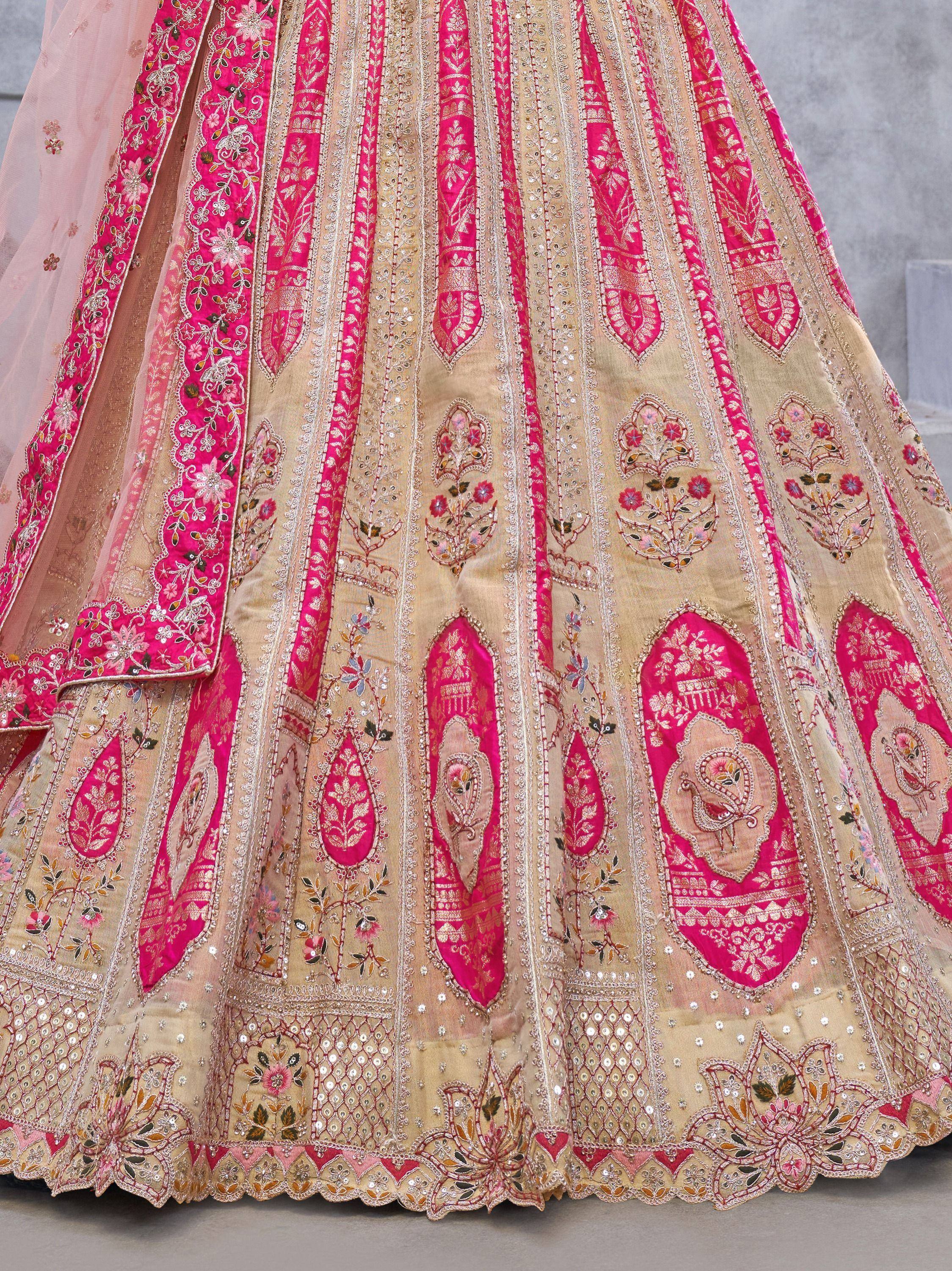 Pink and gold embroidered lehenga choli with floral motifs and sequin detailing, perfect for Indian weddings.
