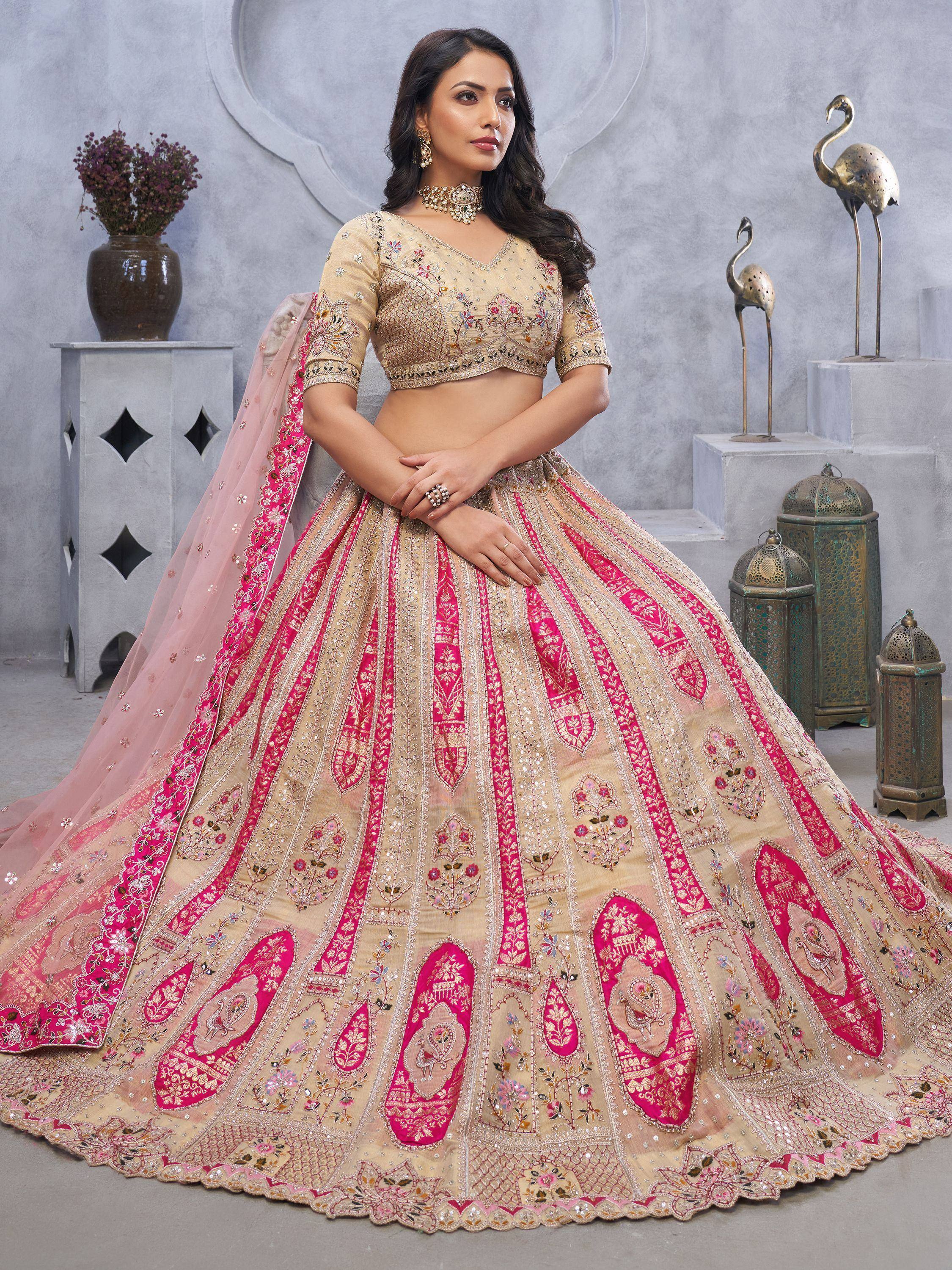 Elegant beige and pink embroidered lehenga choli with floral motifs, perfect for Indian weddings and festive occasions.