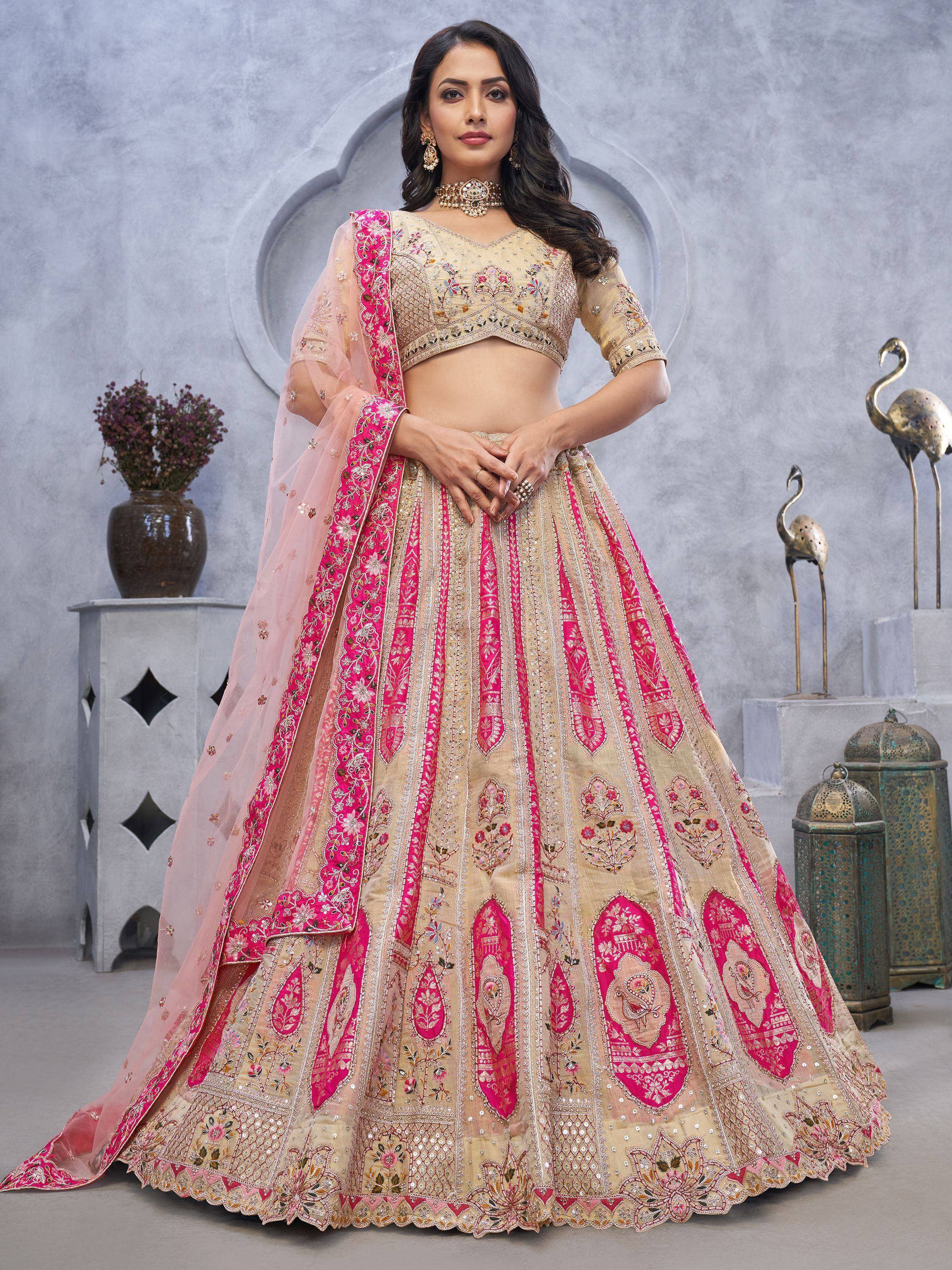 Beige and pink embroidered lehenga choli with floral motifs, perfect for Indian weddings and festive occasions.