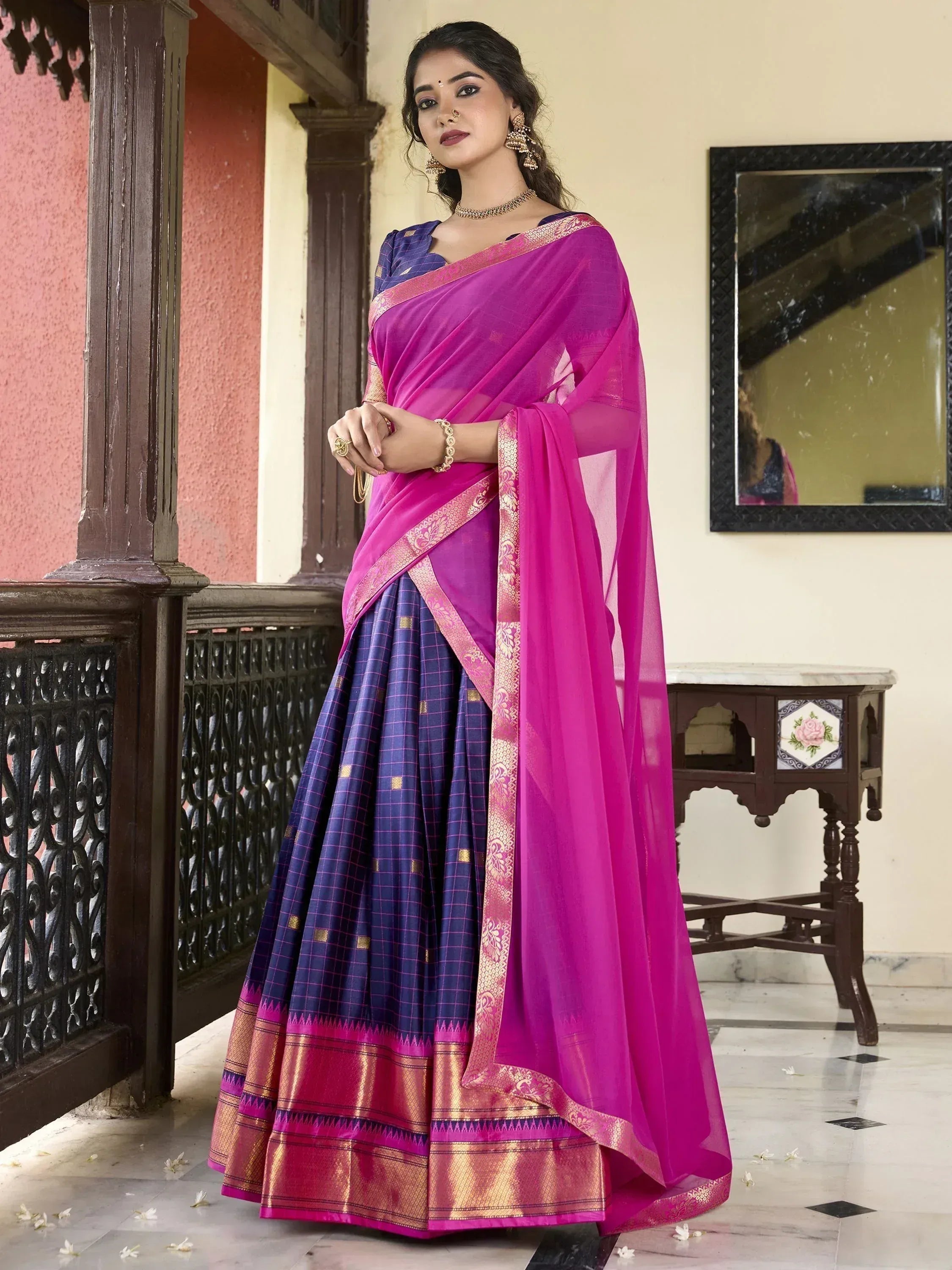 Vibrant pink and purple ethnic saree with gold border, perfect for Indian occasions