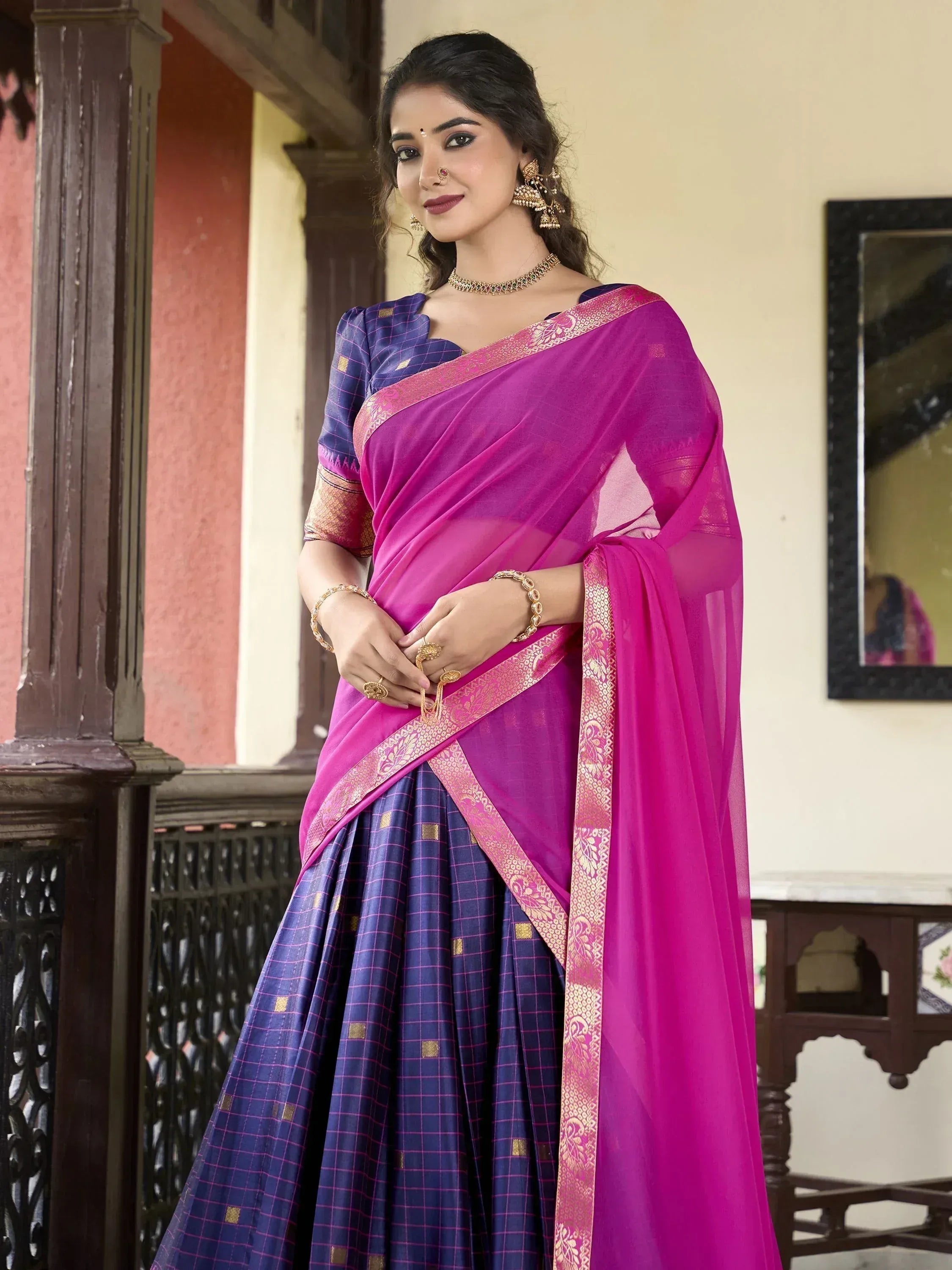 Vibrant pink and blue ethnic saree with gold border, perfect for Indian occasions and festivals