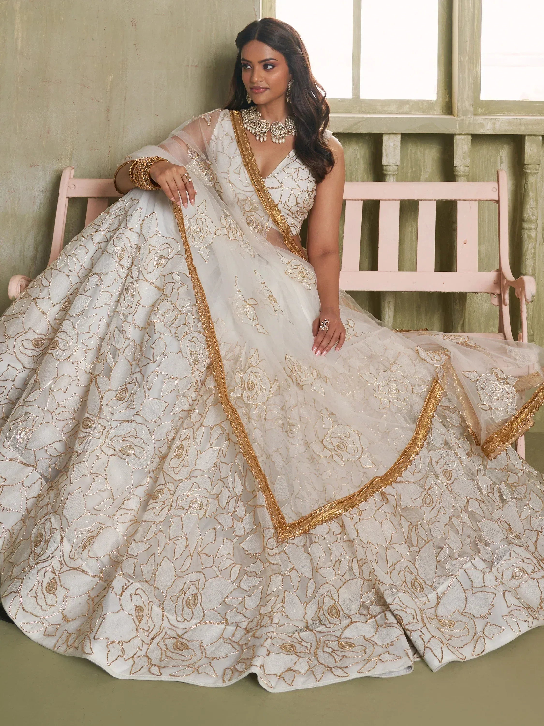 White and gold floral embroidered lehenga choli with sheer dupatta, perfect for Indian weddings and festive occasions