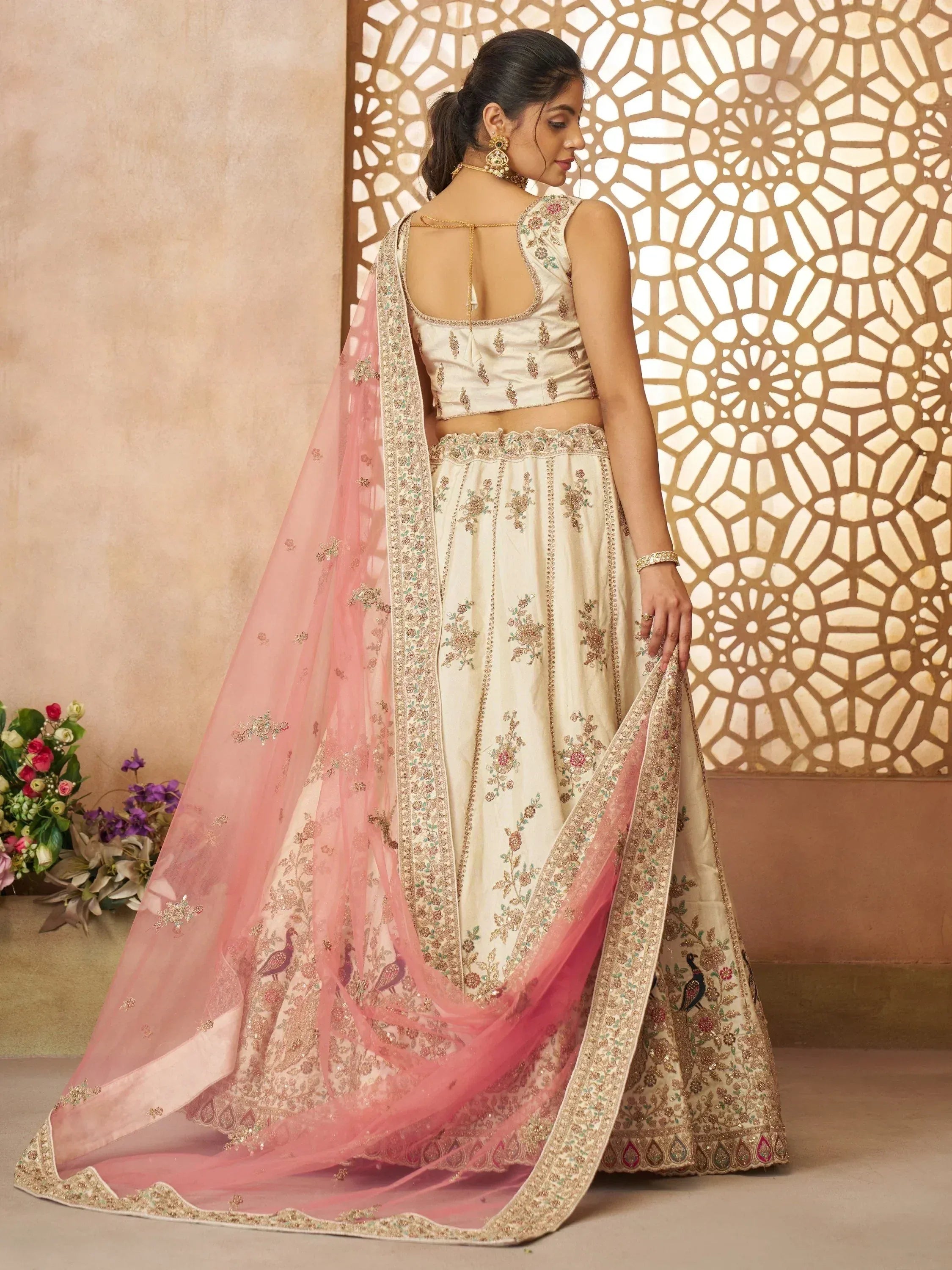Cream embroidered lehenga choli with pink dupatta, floral and peacock motifs, ethnic Indian wear