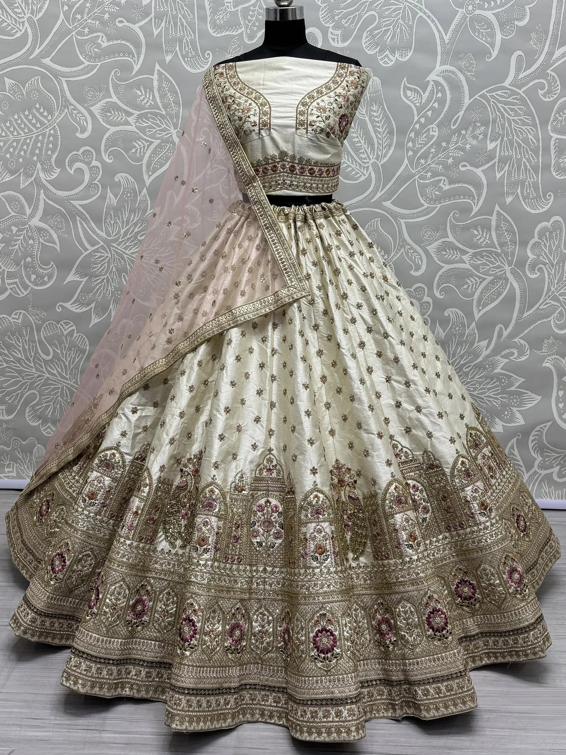 Cream embroidered lehenga choli with floral motifs and pink dupatta, Indian ethnic wear