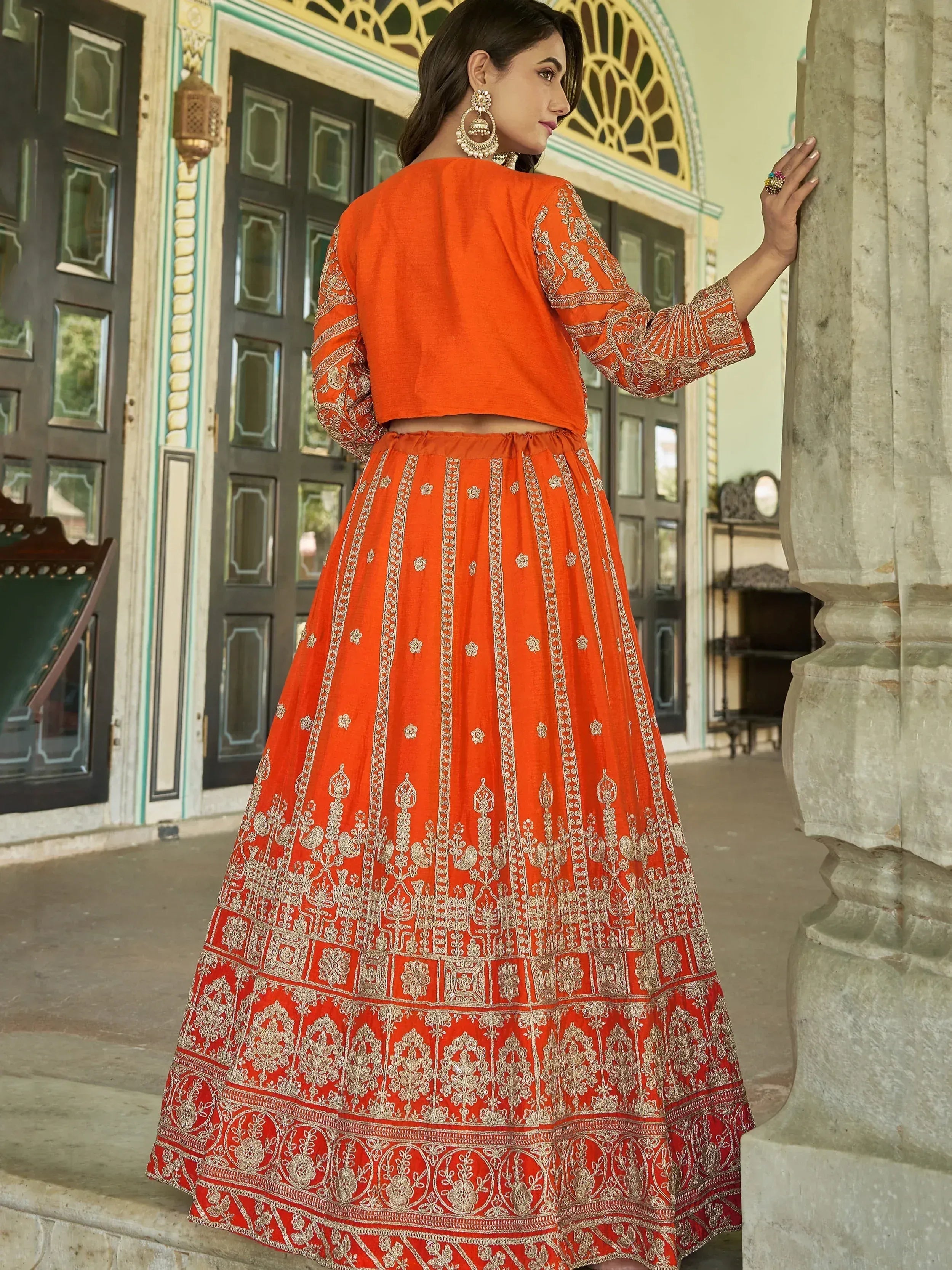 Orange embroidered lehenga choli with gold detailing, perfect for Indian ethnic wear and festive occasions.
