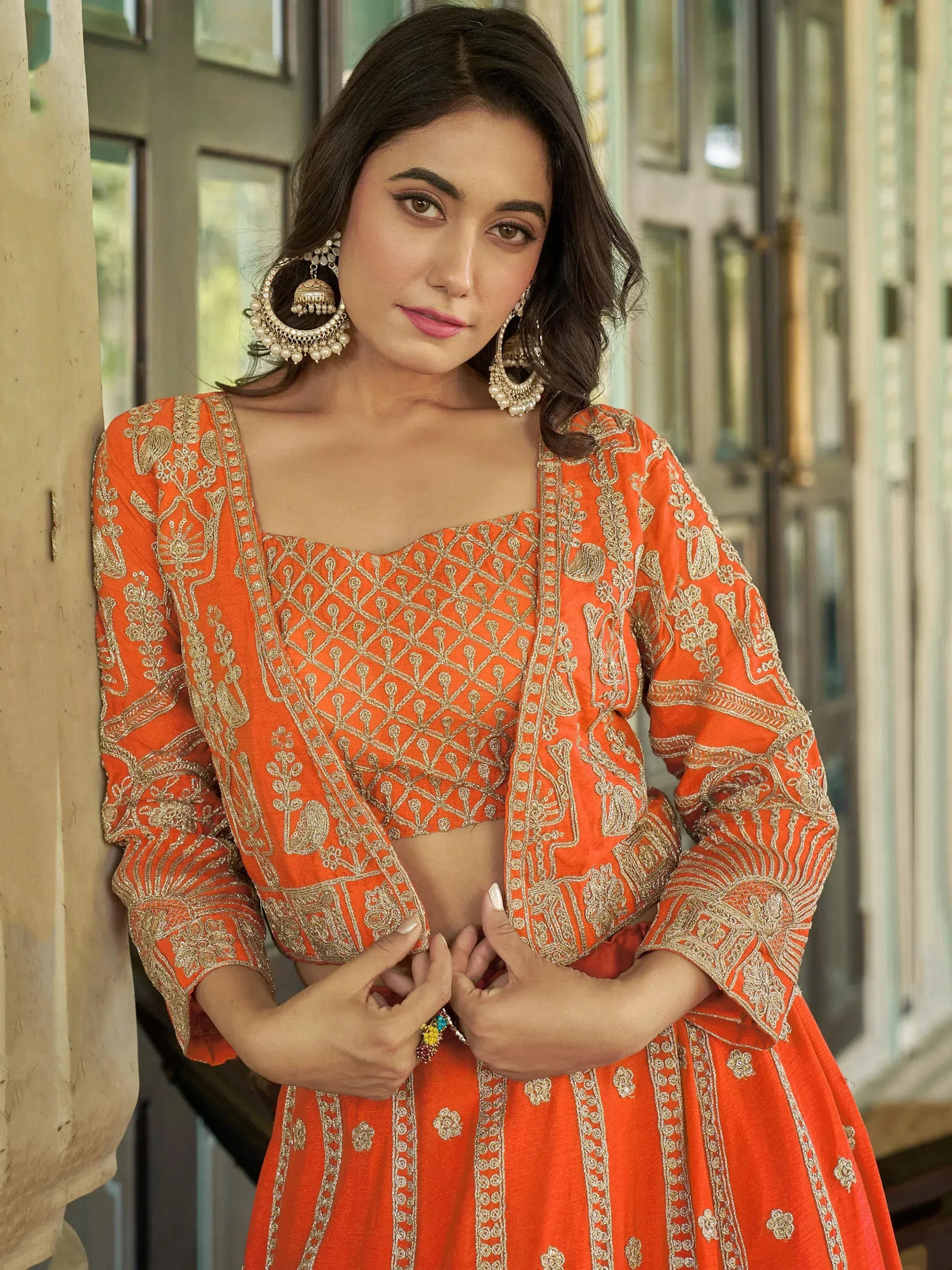 Orange embroidered lehenga choli with gold detailing, perfect for Indian ethnic wear and festive occasions.
