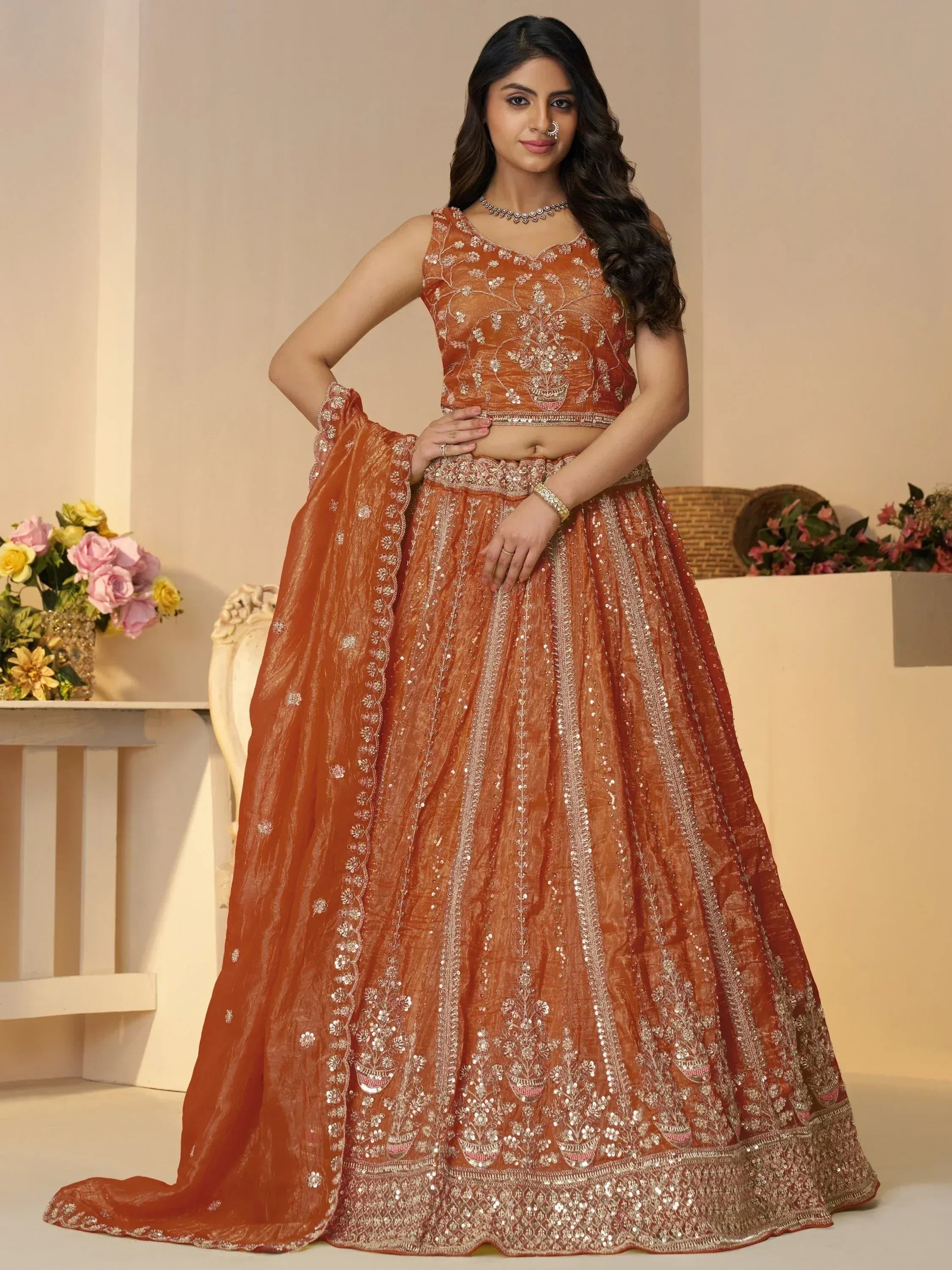 Orange embroidered lehenga choli with floral sequin work, perfect for Indian weddings and festive occasions
