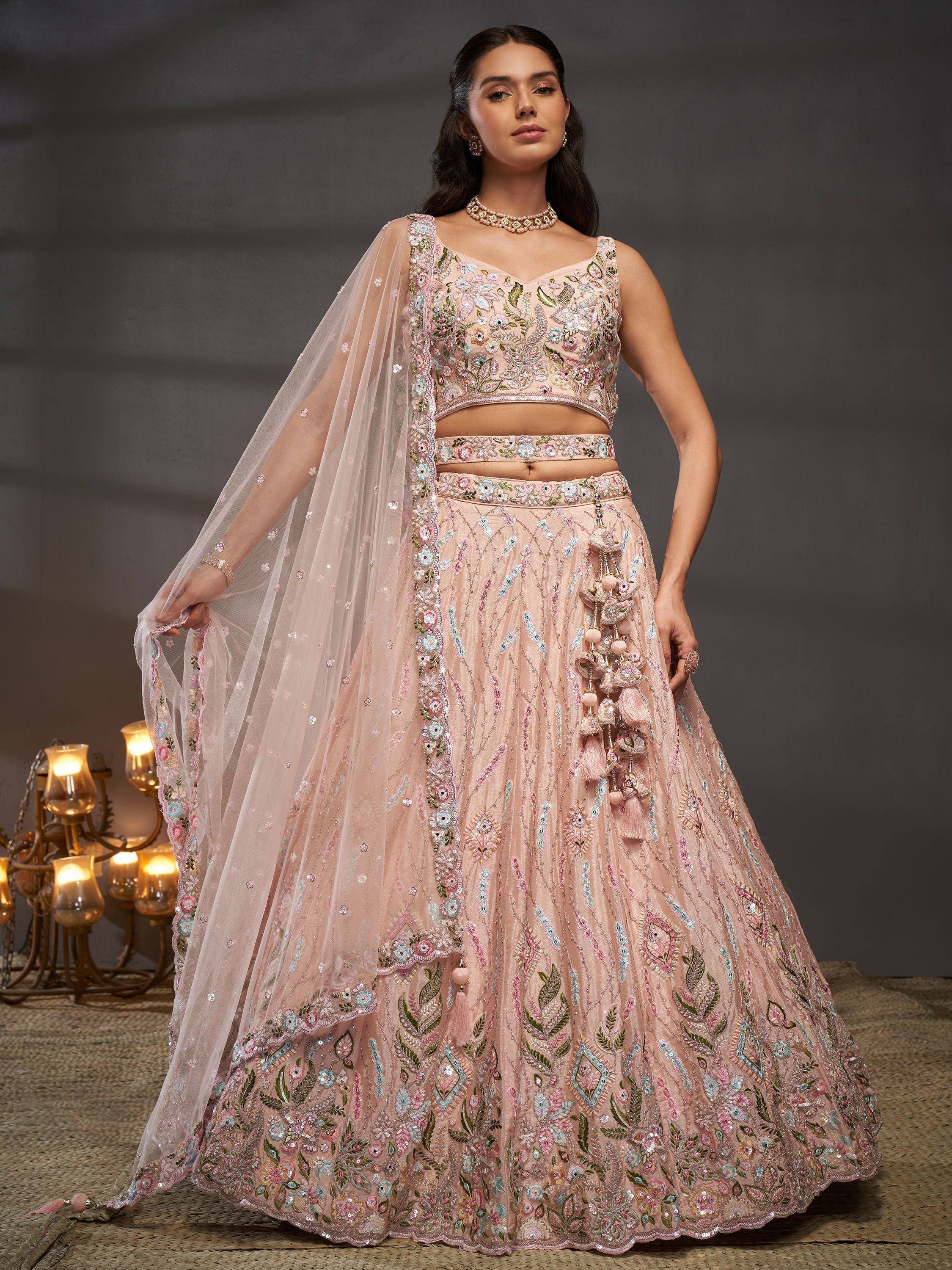 Pink embroidered lehenga choli with floral motifs, tassels, and sheer dupatta for Indian ethnic wear