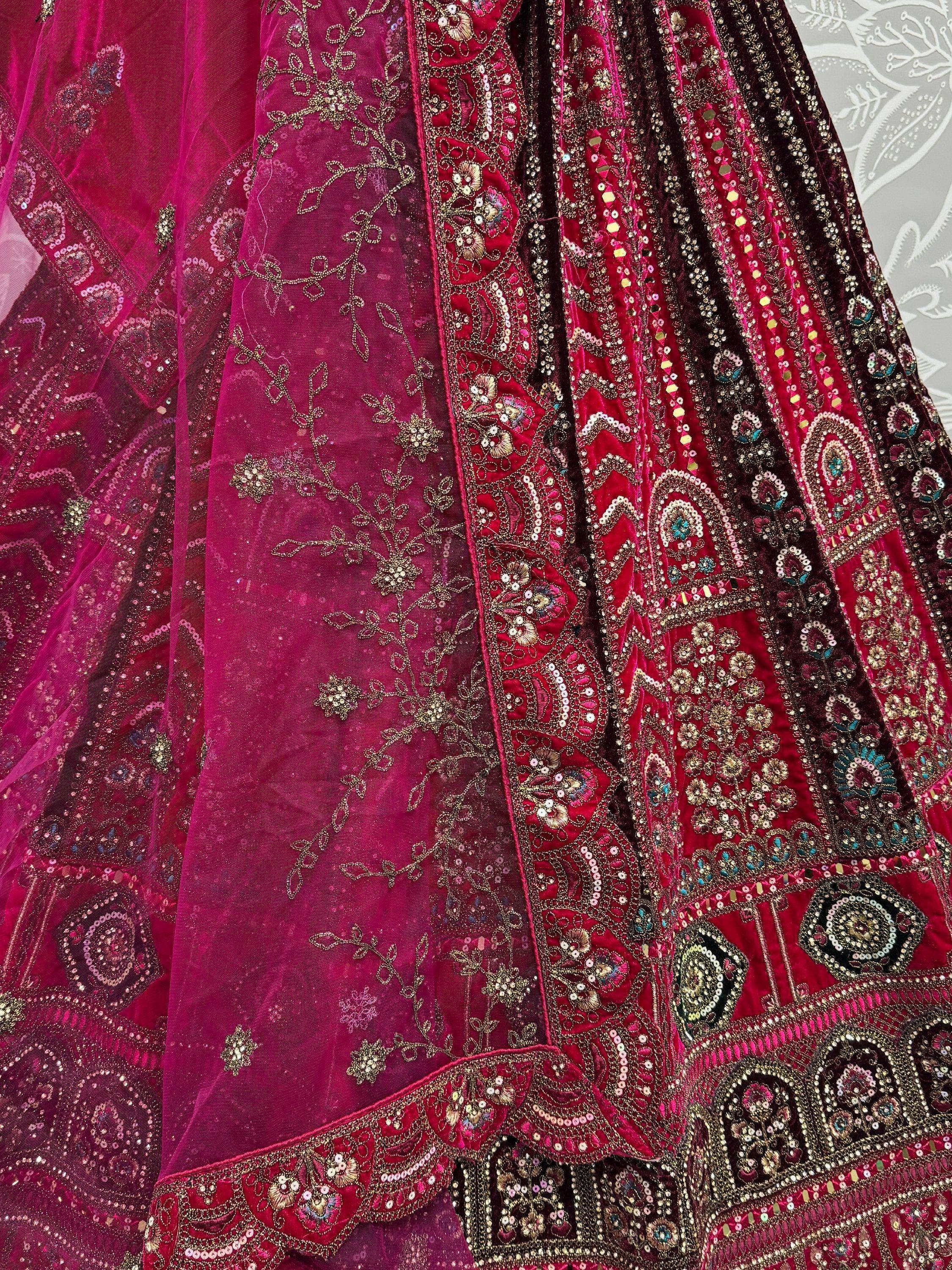 Luxury Indian lehenga choli with intricate gold embroidery and sequin work in deep pink velvet