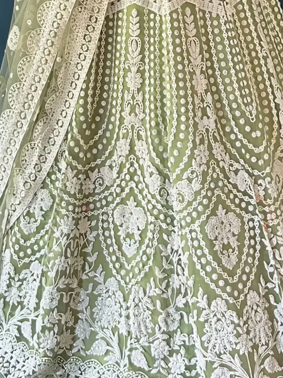 Olive green lehenga with intricate white floral embroidery and lace detailing, perfect for ethnic occasions.
