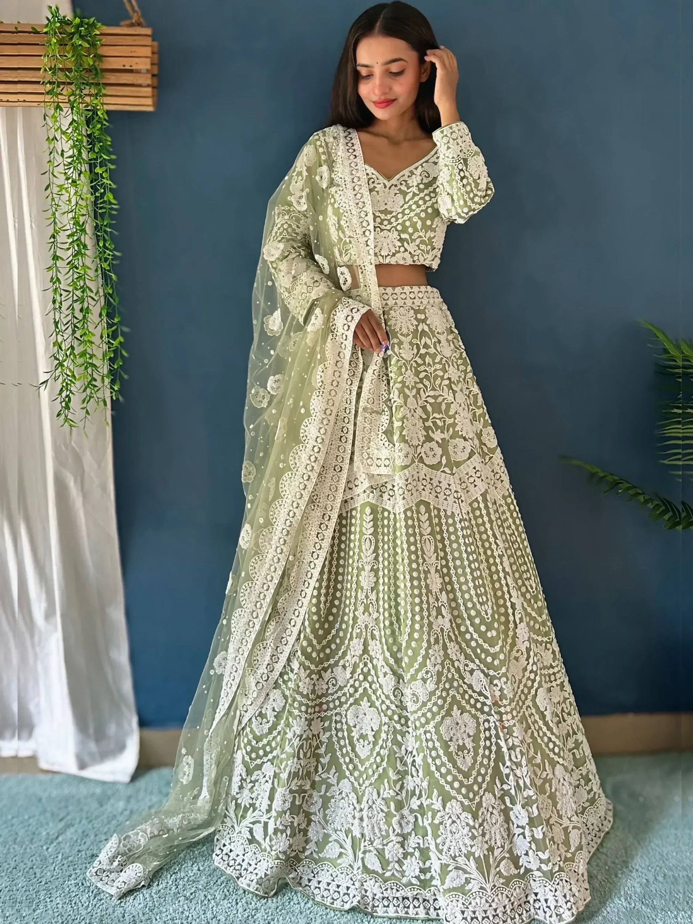Elegant green and white embroidered lehenga choli with floral lace detailing, perfect for Indian ethnic occasions.