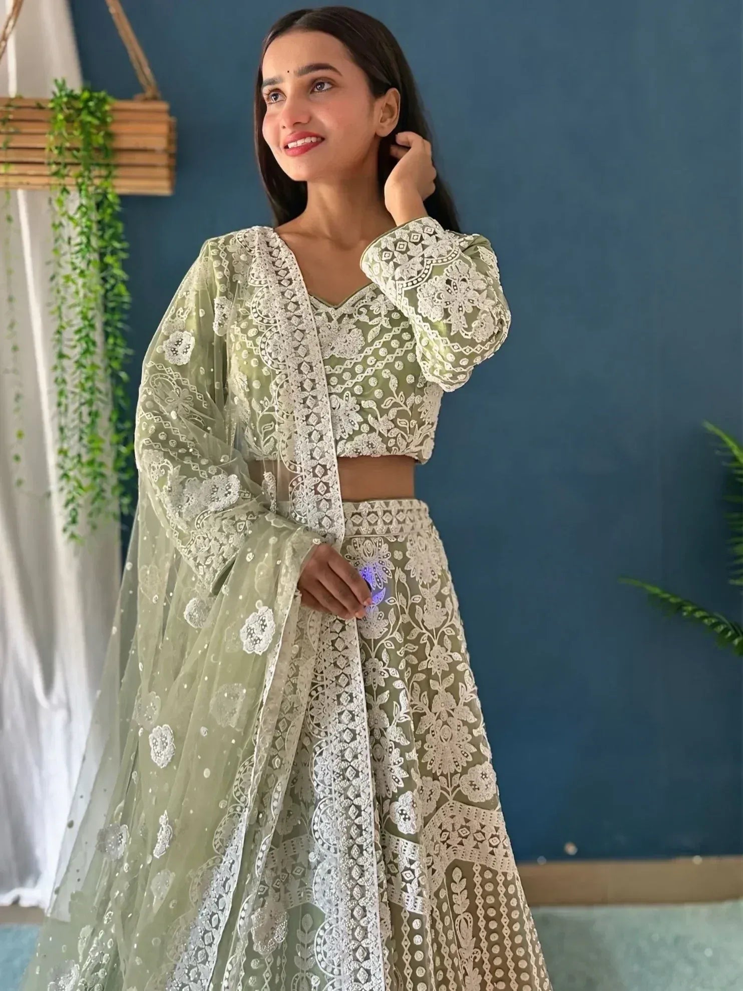 Elegant sage green lehenga choli with white floral embroidery, perfect for Indian ethnic wear occasions.