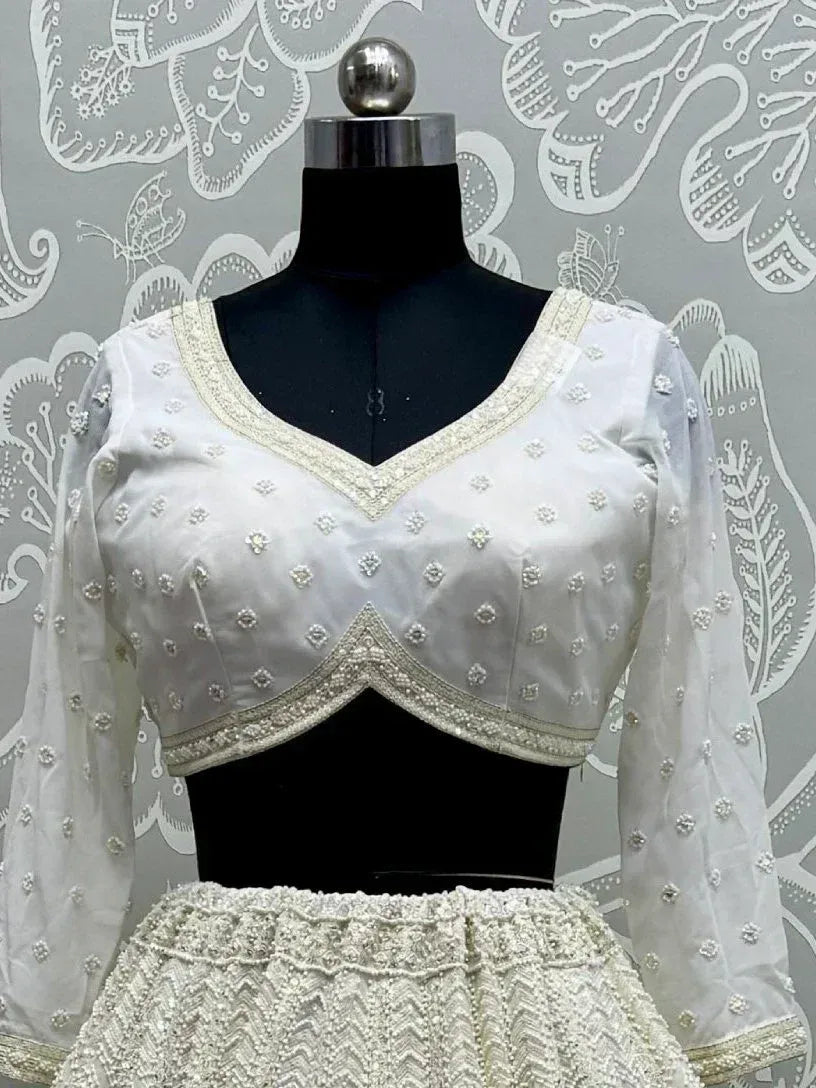 White embroidered lehenga choli with floral beadwork and sheer sleeves, perfect for Indian ethnic wear