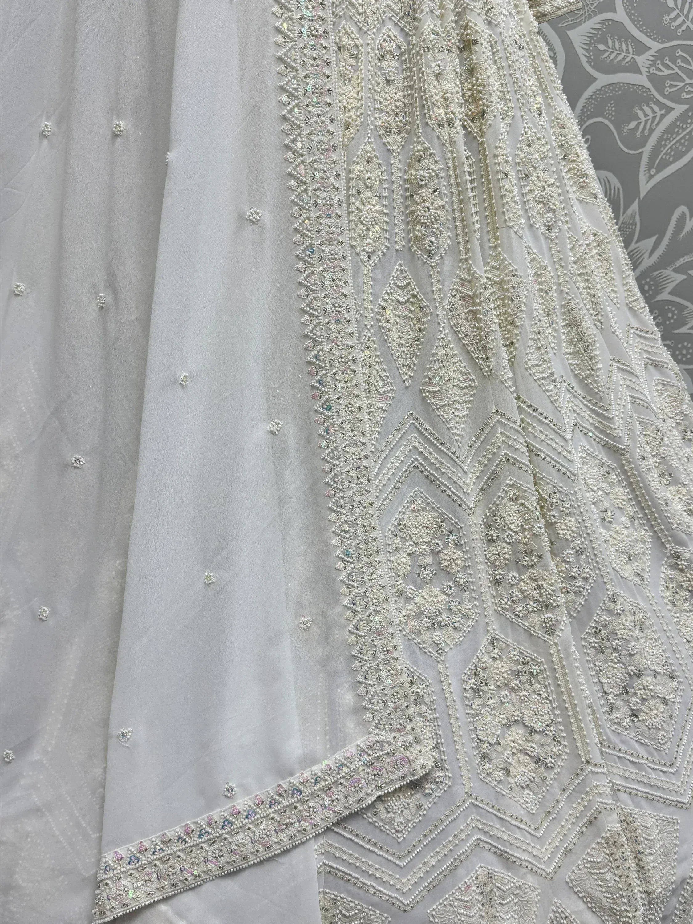 White ethnic gown with intricate beadwork and sequin embroidery, perfect for Indian weddings and festive occasions.